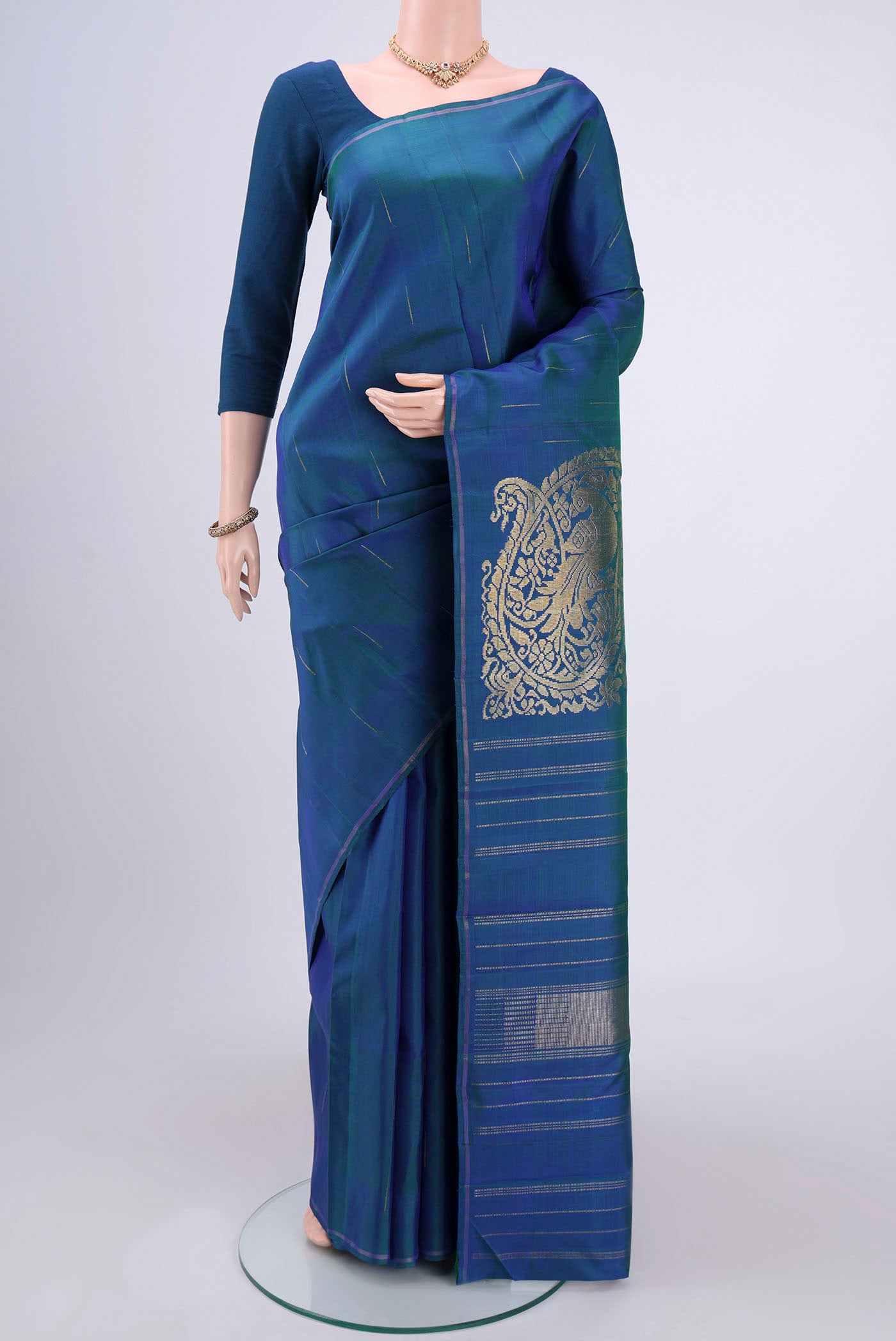 Pure Silk Pure Zari Peacock Blue Dual Tone Kanjivaram Saree with Zari Butta on the body and Zari Border.  displayed on a mannequin