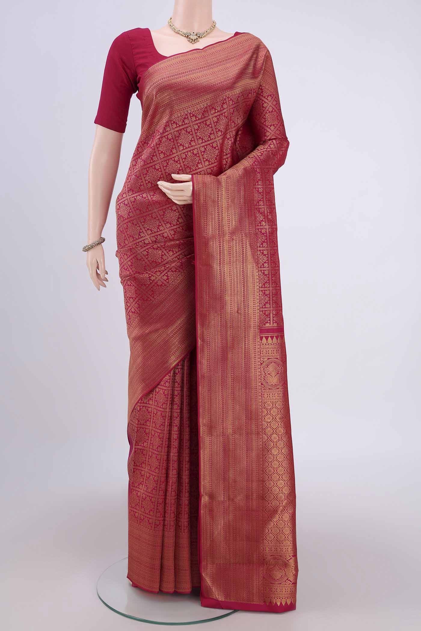 Dark Pink Kanchipuram Silk Saree with Zari Brocade on the body and Zari Border.  displayed on a mannequin