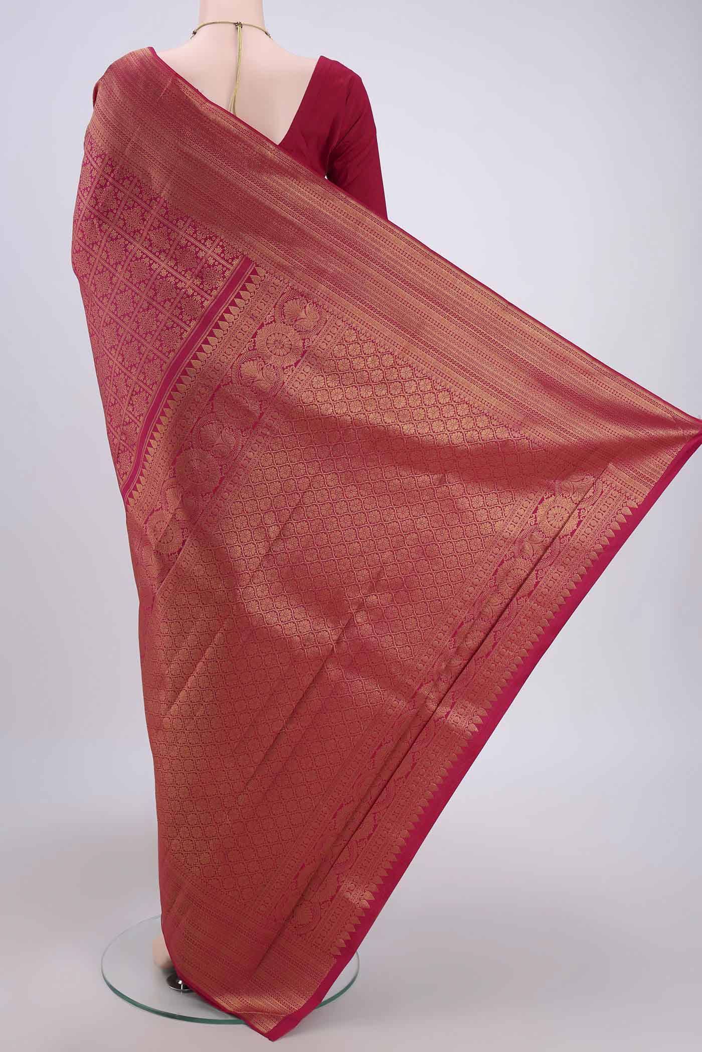 Flat view of Dark Pink Kanchipuram Silk Saree with Zari Brocade on the body and Zari Border. 