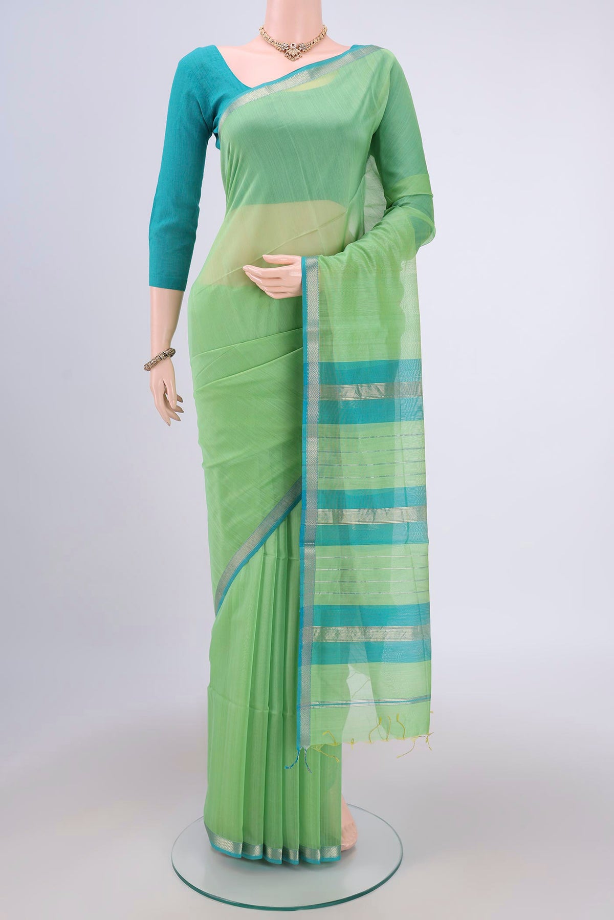 Acid Green Maheshwari Silk Cotton Saree with Plain Body and Zari Border.  displayed on a mannequin