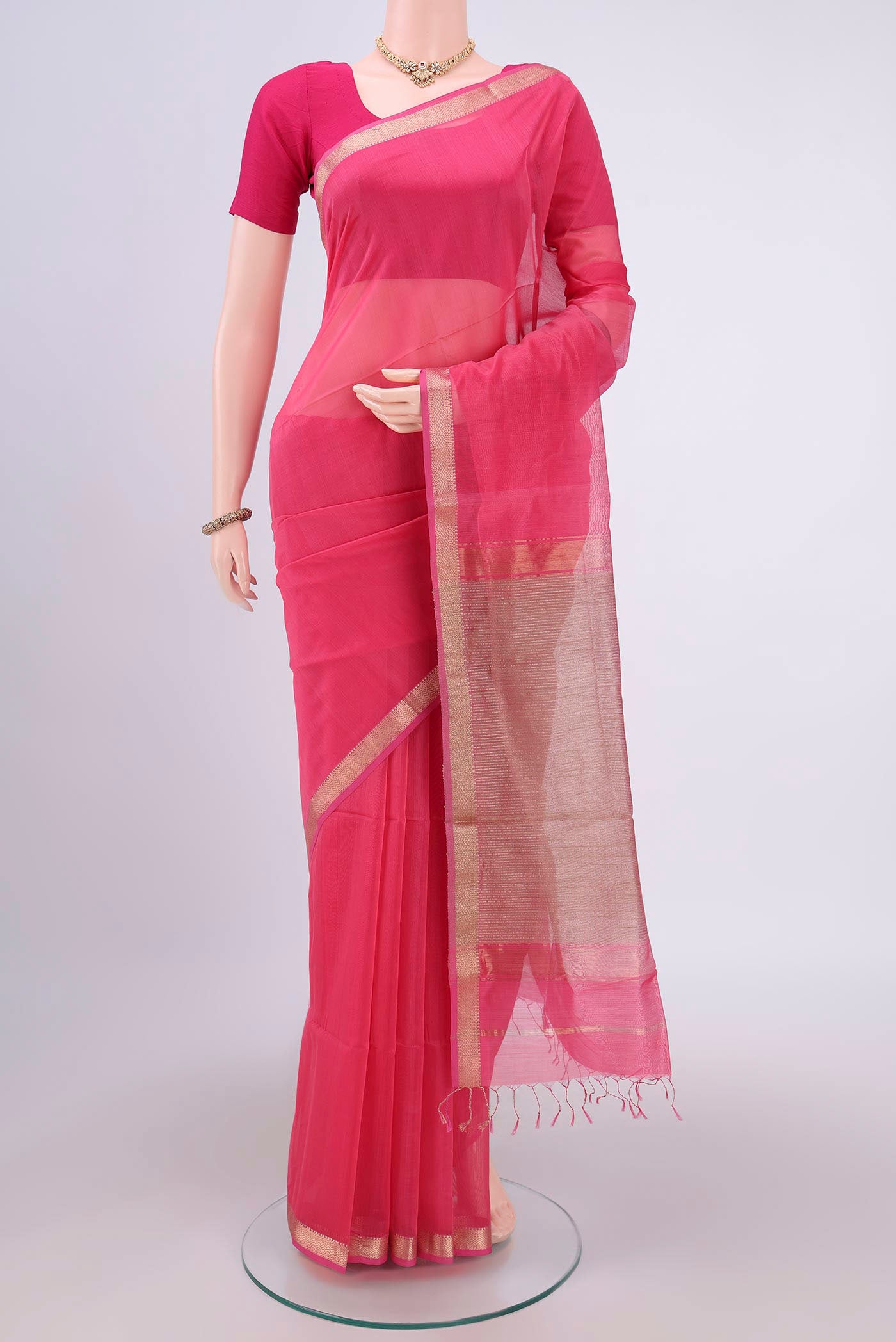 Pink Maheshwari Silk Cotton Saree with Plain Body and Zari Border.  displayed on a mannequin