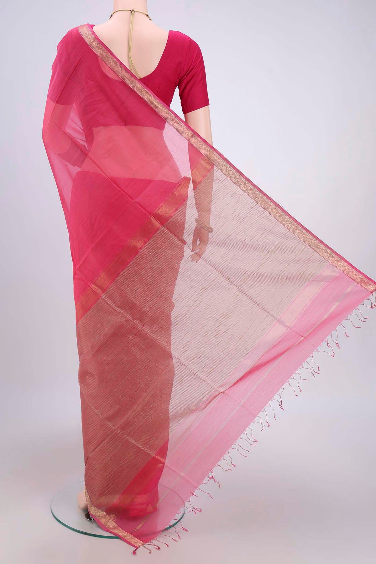Flat view of Pink Maheshwari Silk Cotton Saree with Plain Body and Zari Border. 
