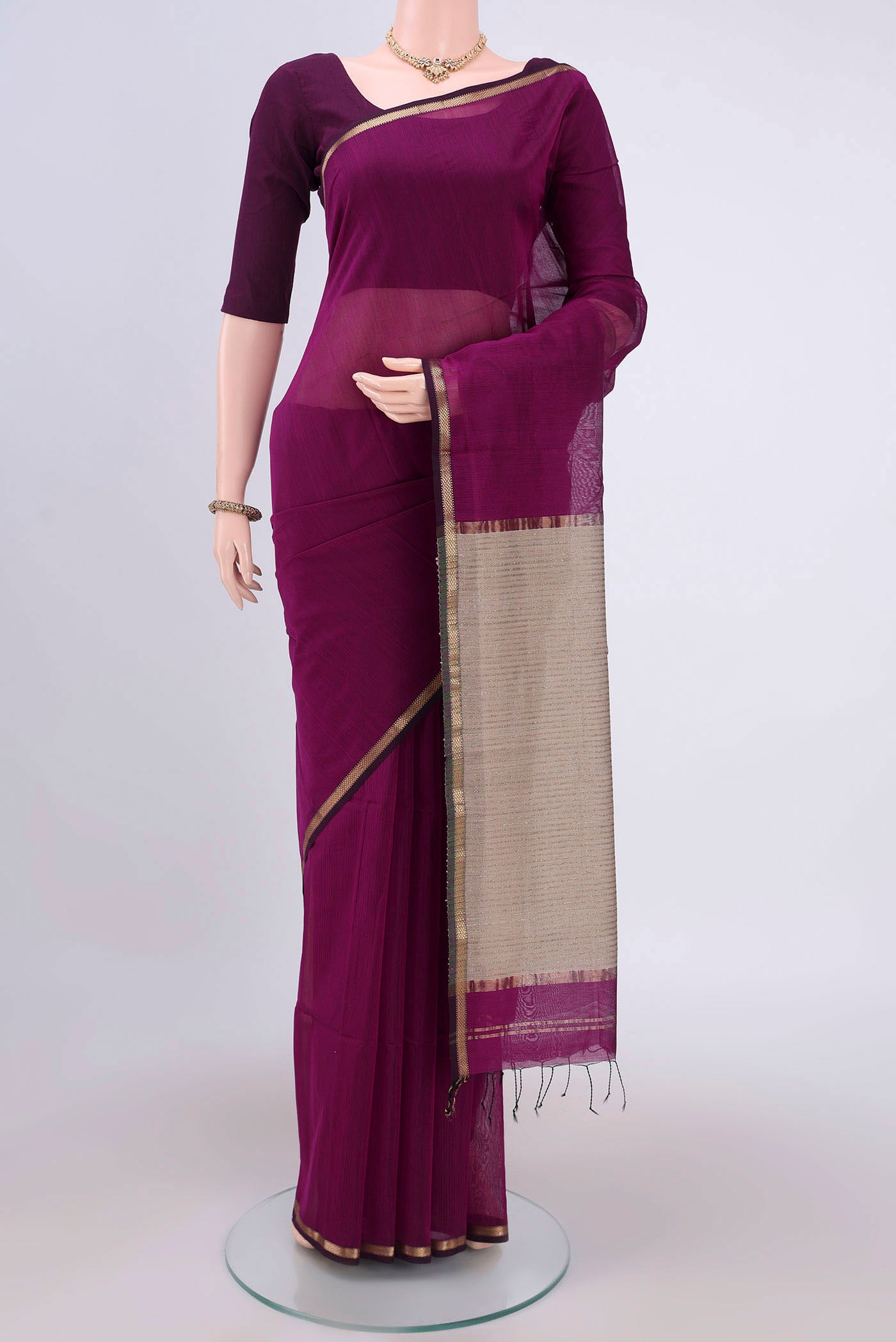 Purple Maheshwari Silk Cotton Saree with Plain Body and Zari Border.  displayed on a mannequin