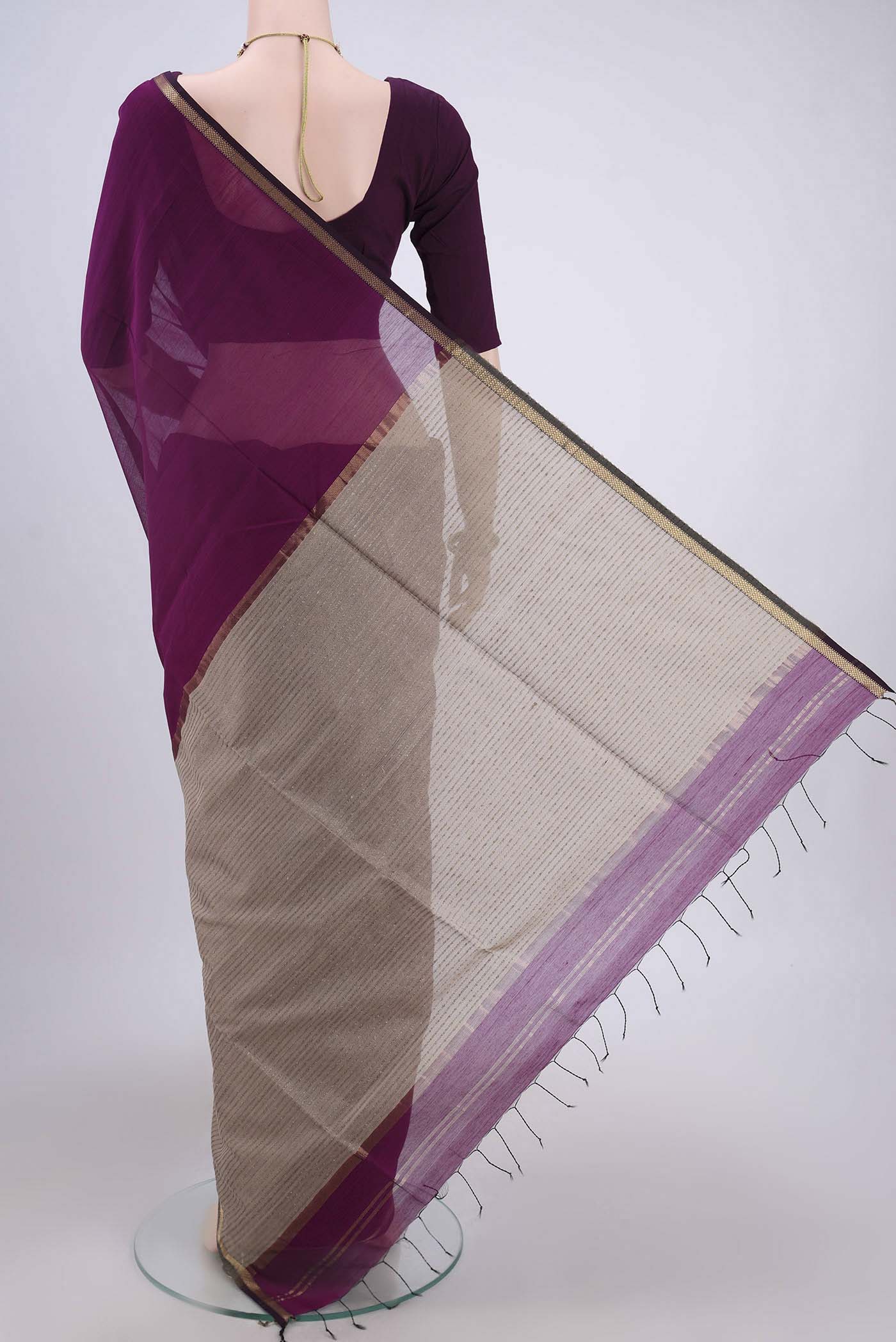 Flat view of Purple Maheshwari Silk Cotton Saree with Plain Body and Zari Border. 