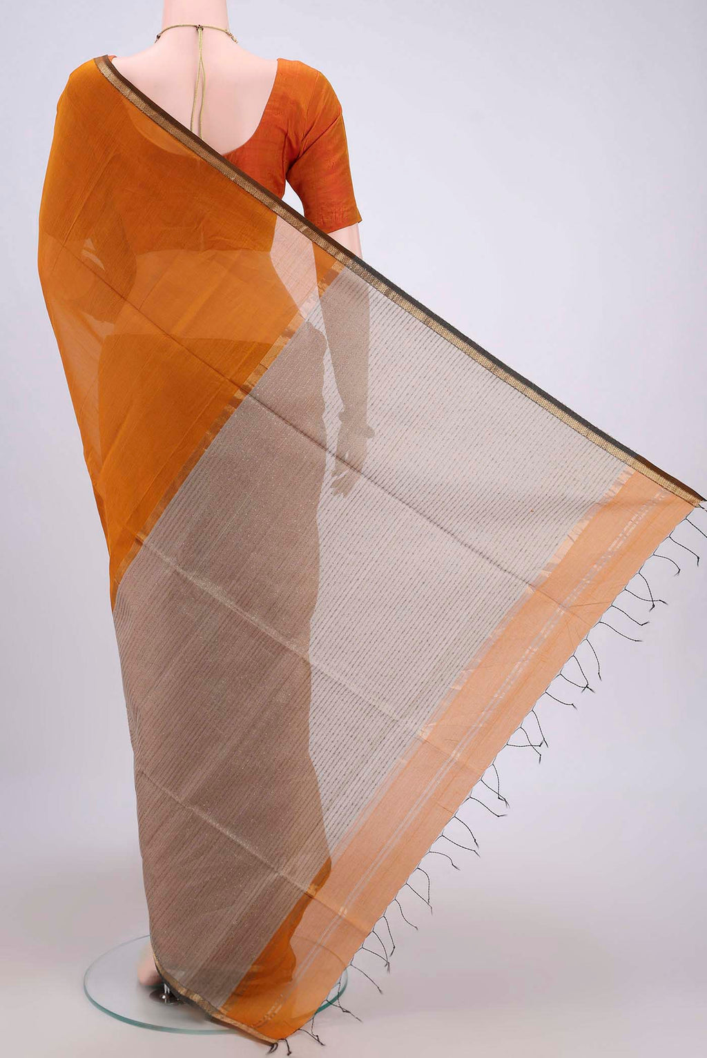 Flat view of Mustard Maheshwari Silk Cotton Saree with Plain Body and Zari Border. 