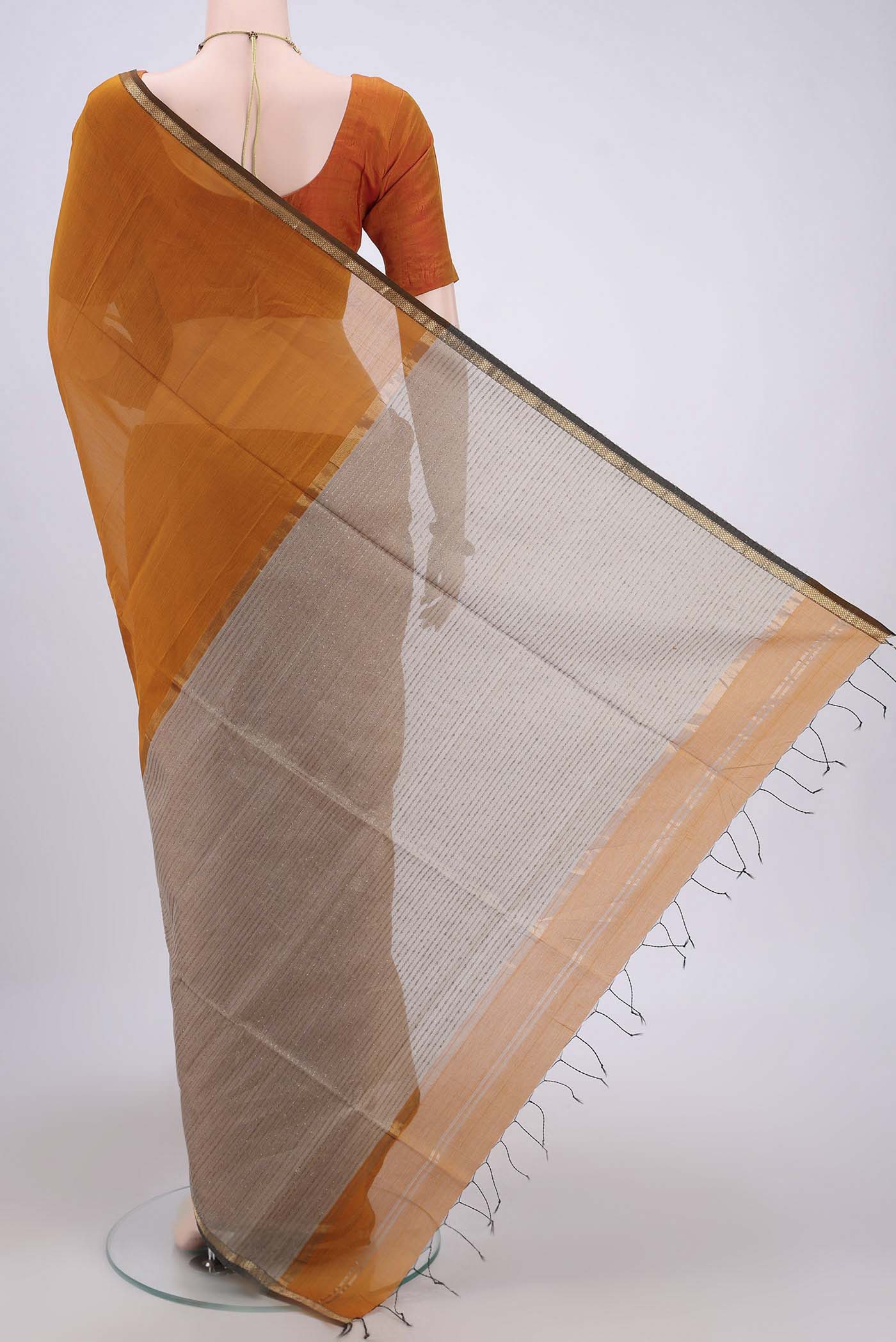 Flat view of Mustard Maheshwari Silk Cotton Saree with Plain Body and Zari Border. 