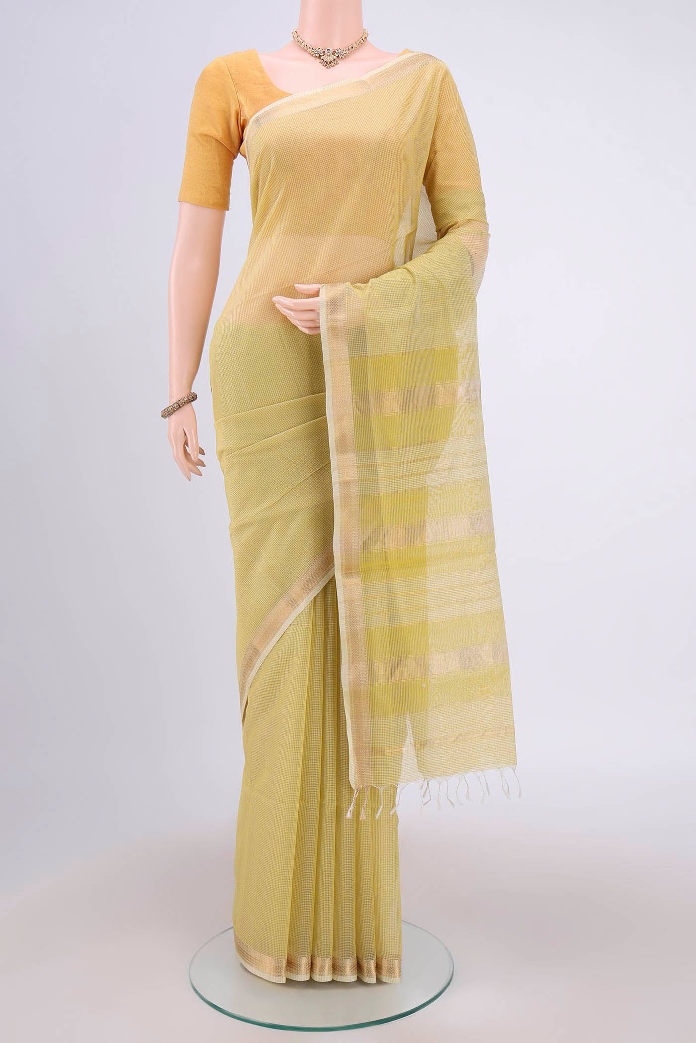 Lemon Yellow Maheshwari Silk Cotton Saree with Checked design on the body and Zari Border.  displayed on a mannequin