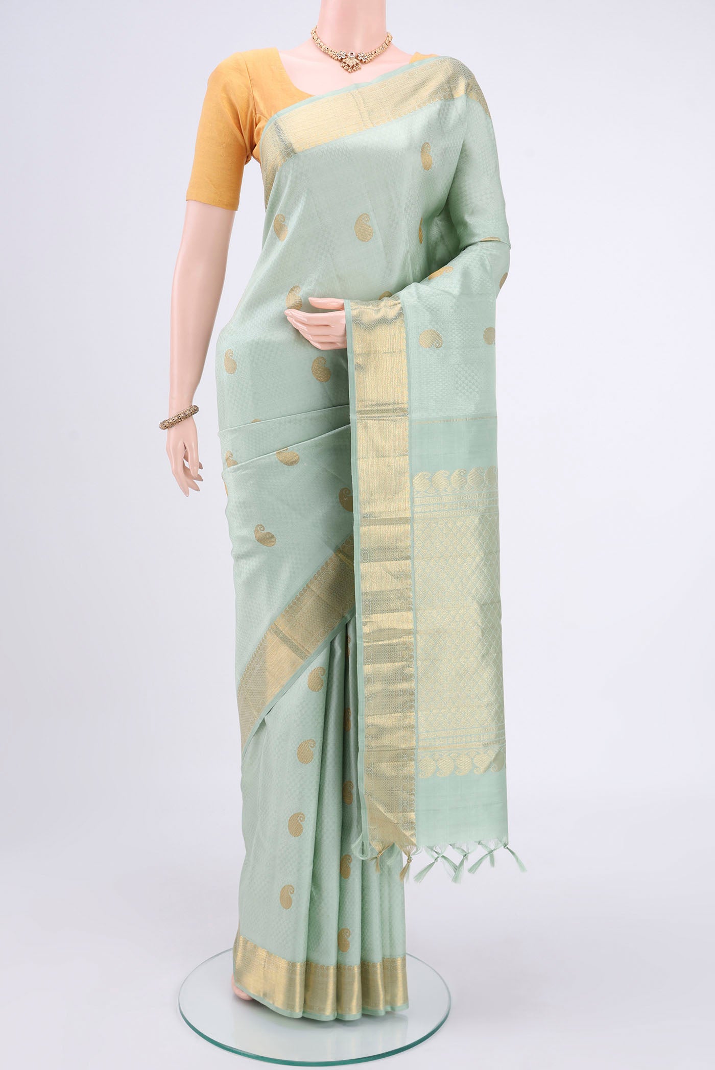 Mint Green Kanjivaram Silk Saree with Jacquard With Zari Butta on the body and Zari Border.  displayed on a mannequin