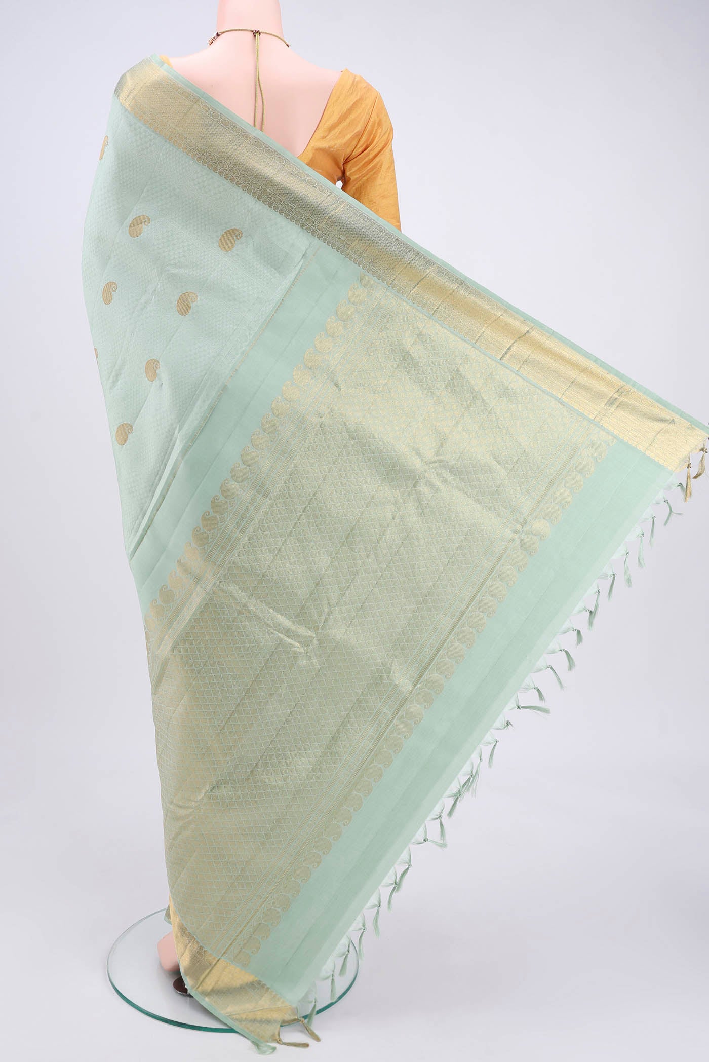 Flat view of Mint Green Kanjivaram Silk Saree with Jacquard With Zari Butta on the body and Zari Border. 
