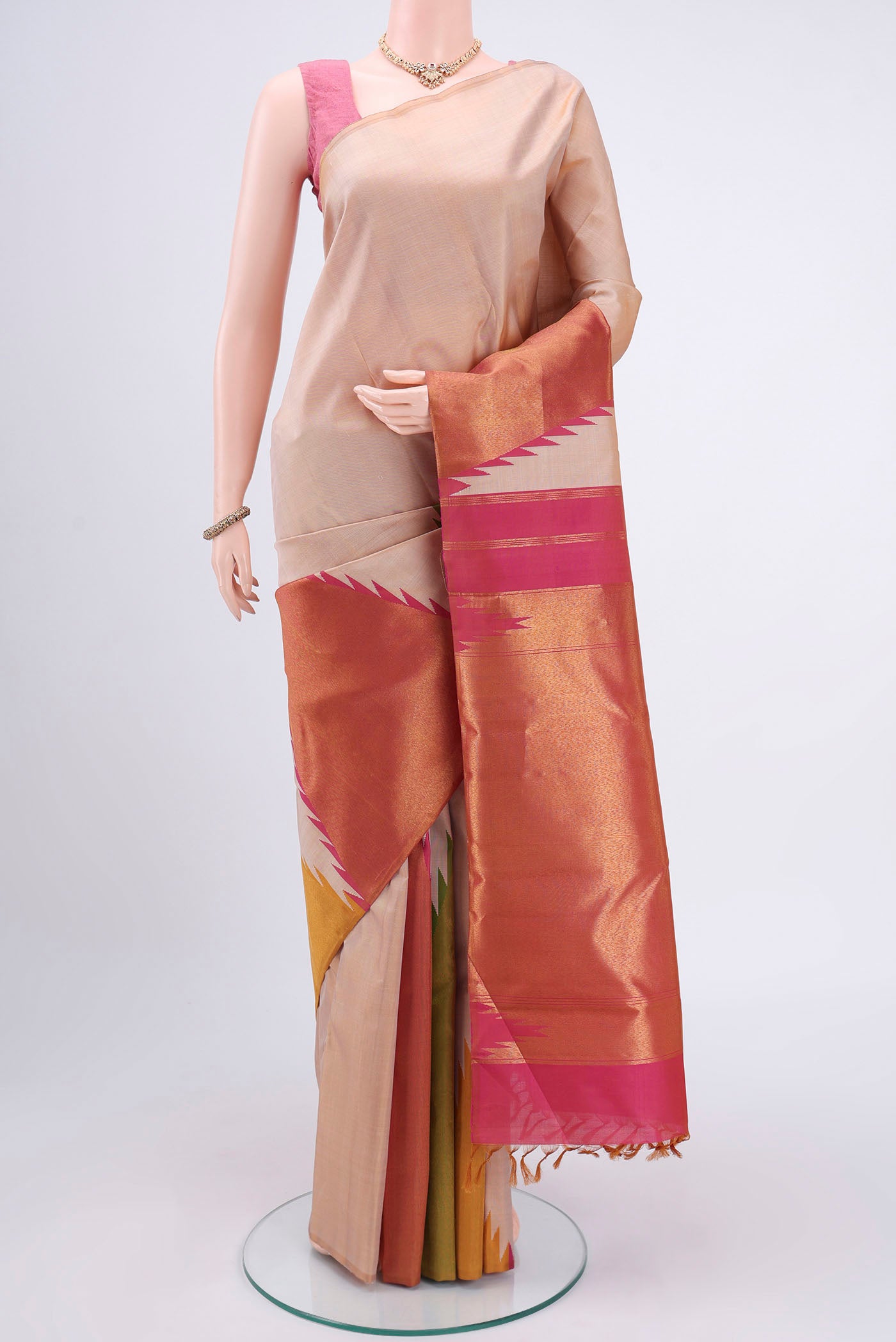 Beige Kanjivaram Silk Saree with Zari Butta on the body and Temple Border.  displayed on a mannequin