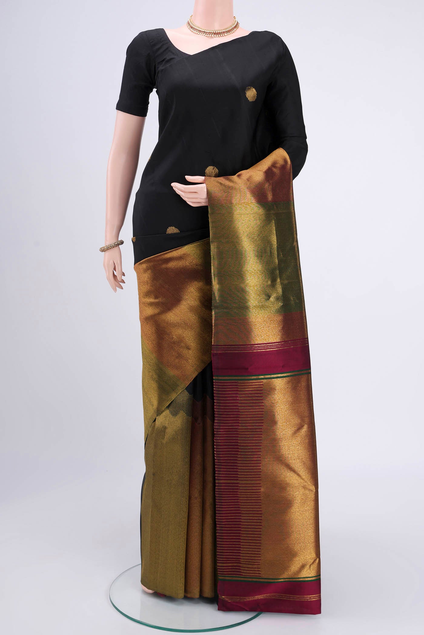 Black Kanchipuram Silk Saree with Zari Butta on the body and Zari Border.  displayed on a mannequin