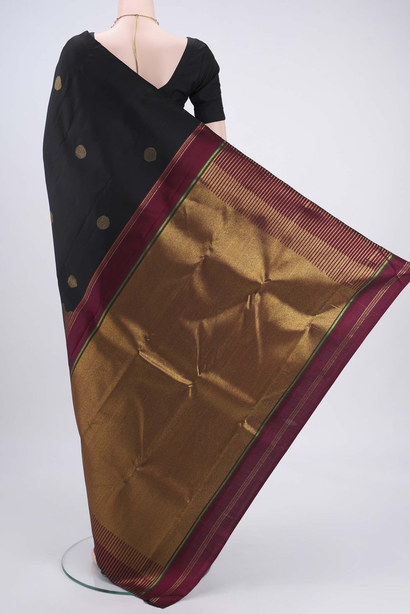 Flat view of Black Kanchipuram Silk Saree with Zari Butta on the body and Zari Border. 