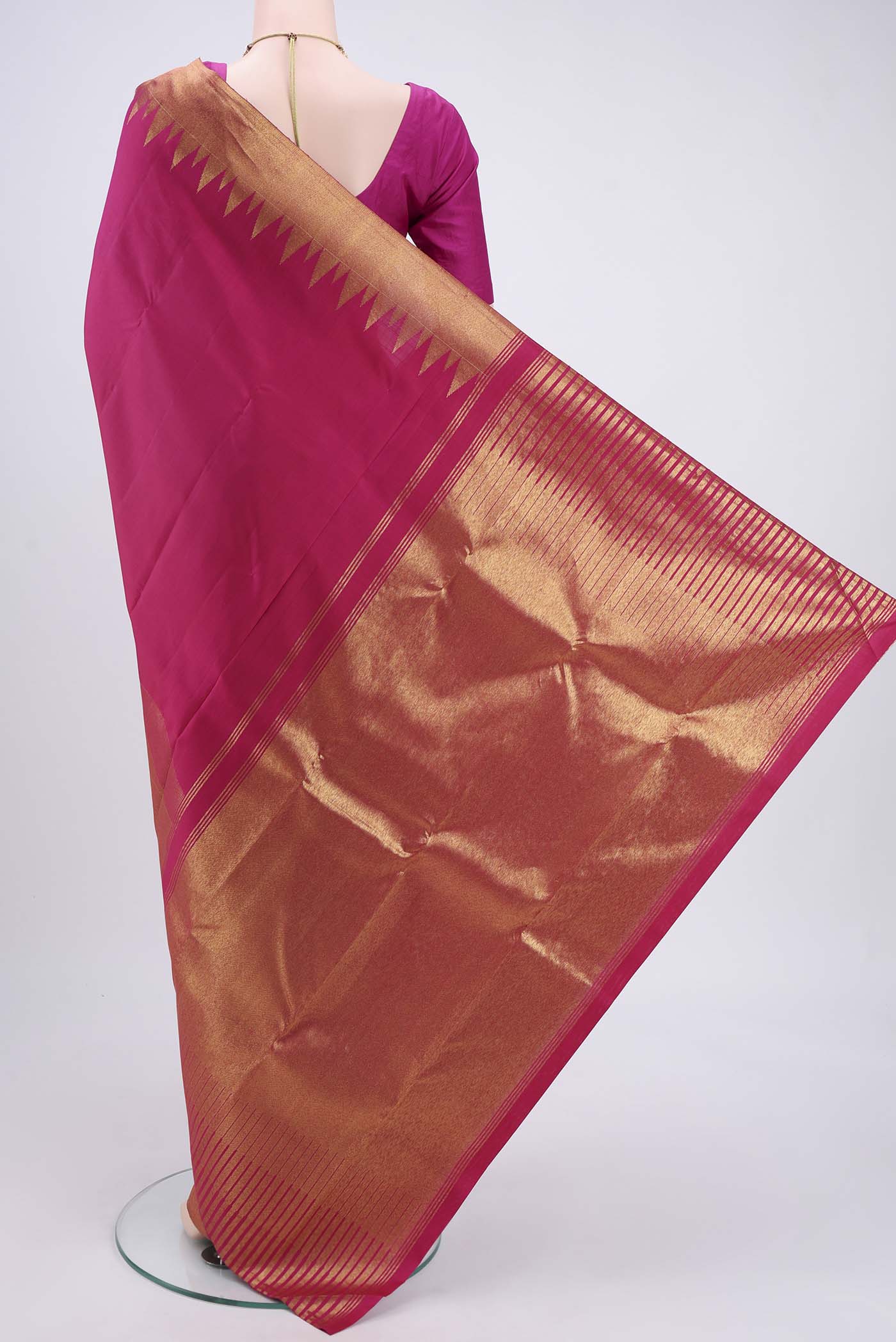 Flat view of Rani Pink Kanjivaram Silk Saree with Plain Body and Rising Temple Border. 