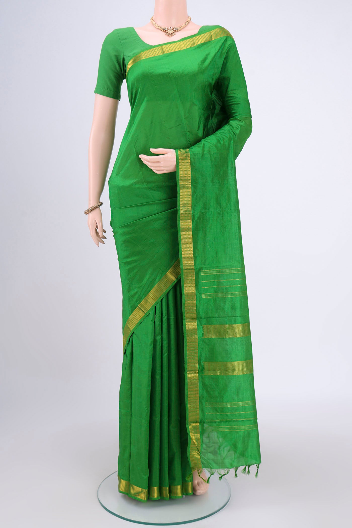 Green Dual Tone Kanchipuram Silk Saree with Plain Body and Zari Border.  displayed on a mannequin