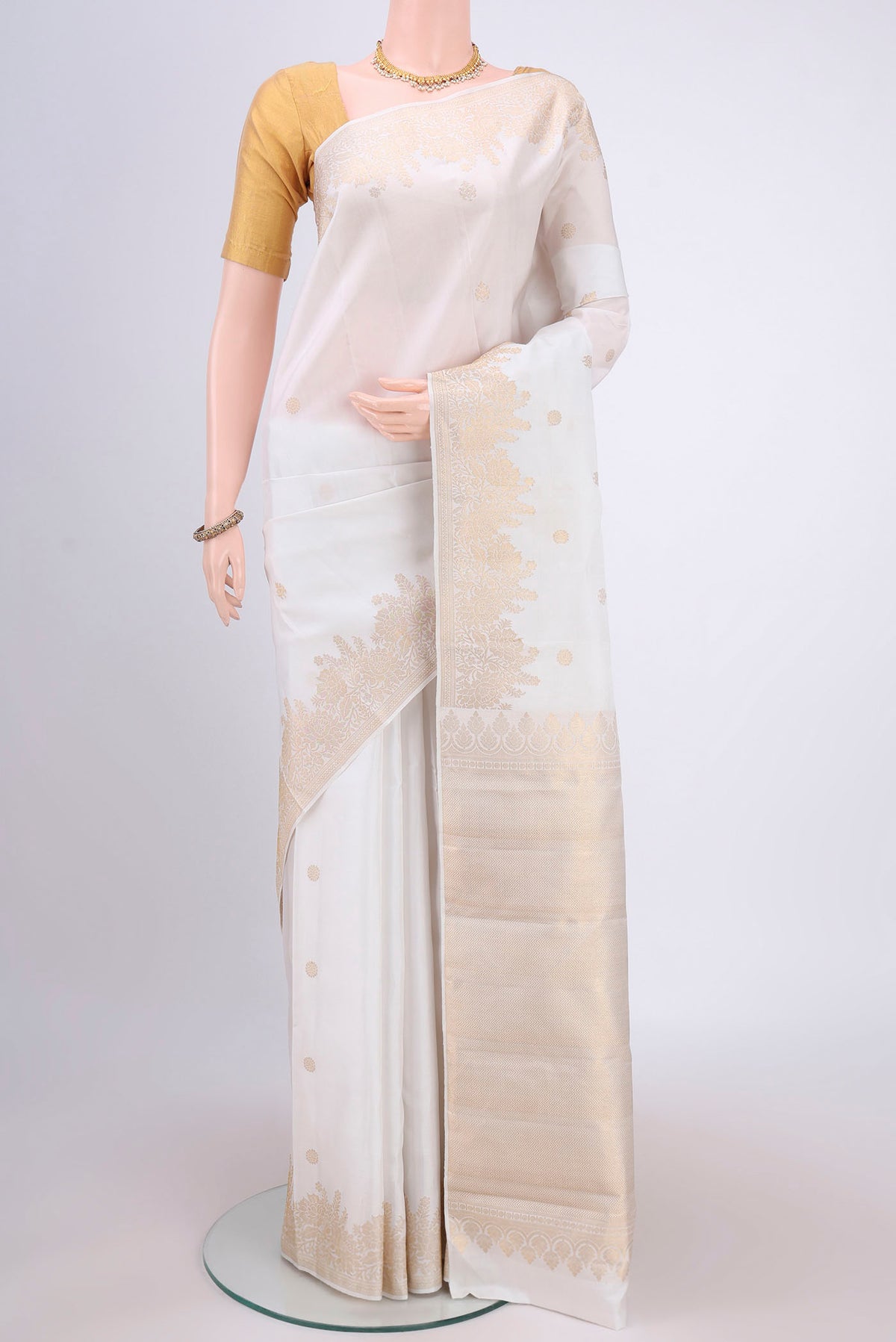 White Dual Tone Kanjivaram Silk Saree with Zari Butta on the body and Zari Border.  displayed on a mannequin
