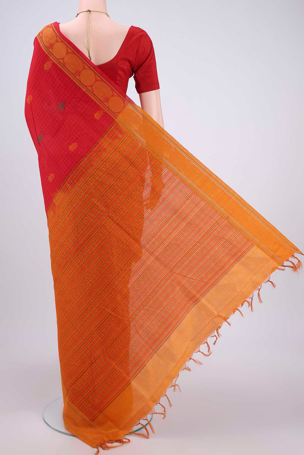 Flat view of Red Blended Poly Cotton Saree with Zari Butta on the body and Zari Border. 