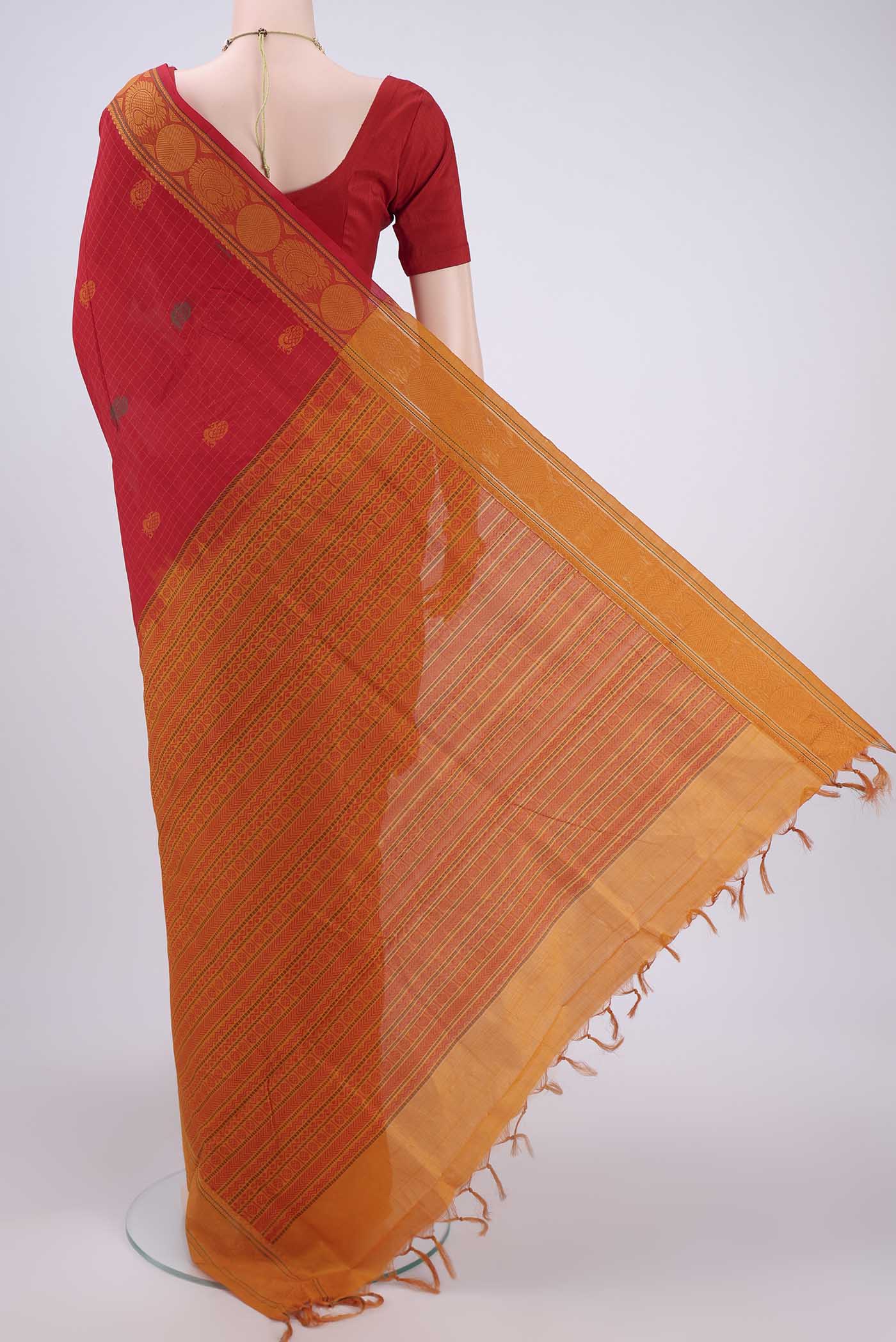 Flat view of Red Blended Poly Cotton Saree with Zari Butta on the body and Zari Border. 