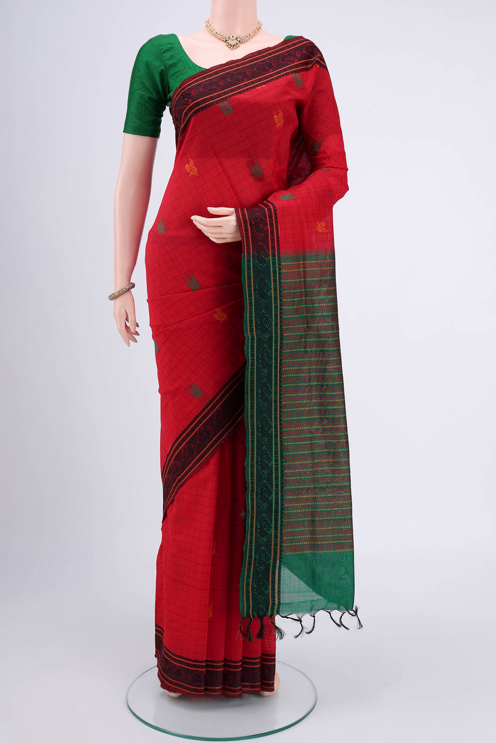 Red Blended Poly Cotton Saree with Checked design on the body and Thread Border.  displayed on a mannequin