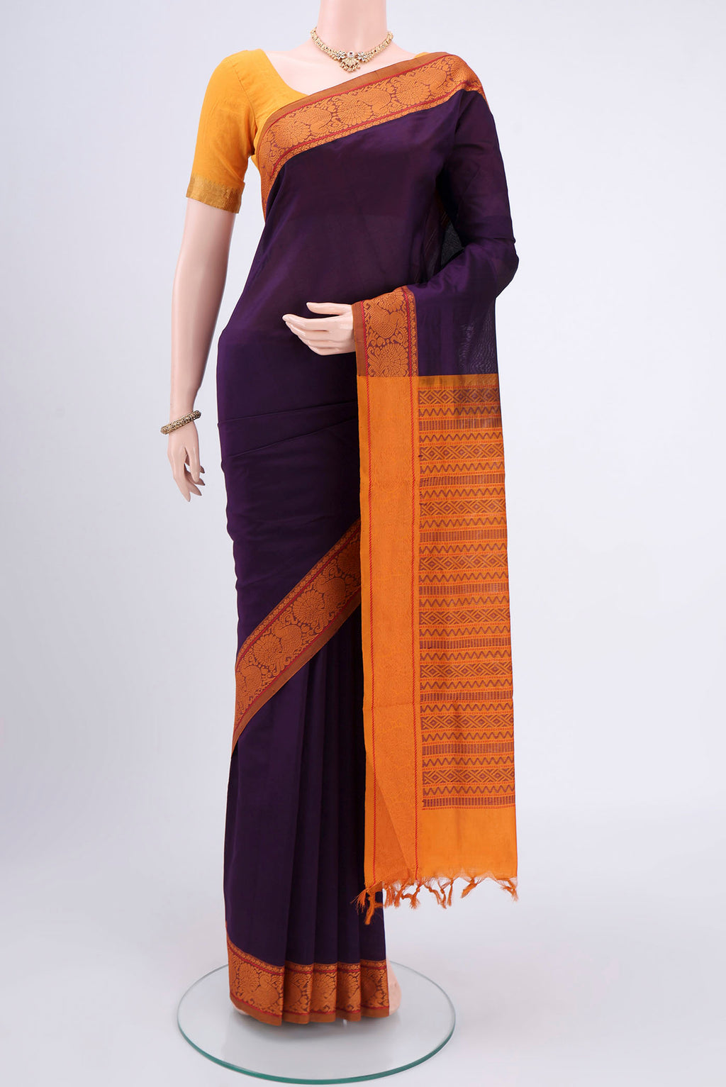 Burgundy Blended Poly Cotton Saree with Plain Body and Thread Border.  displayed on a mannequin