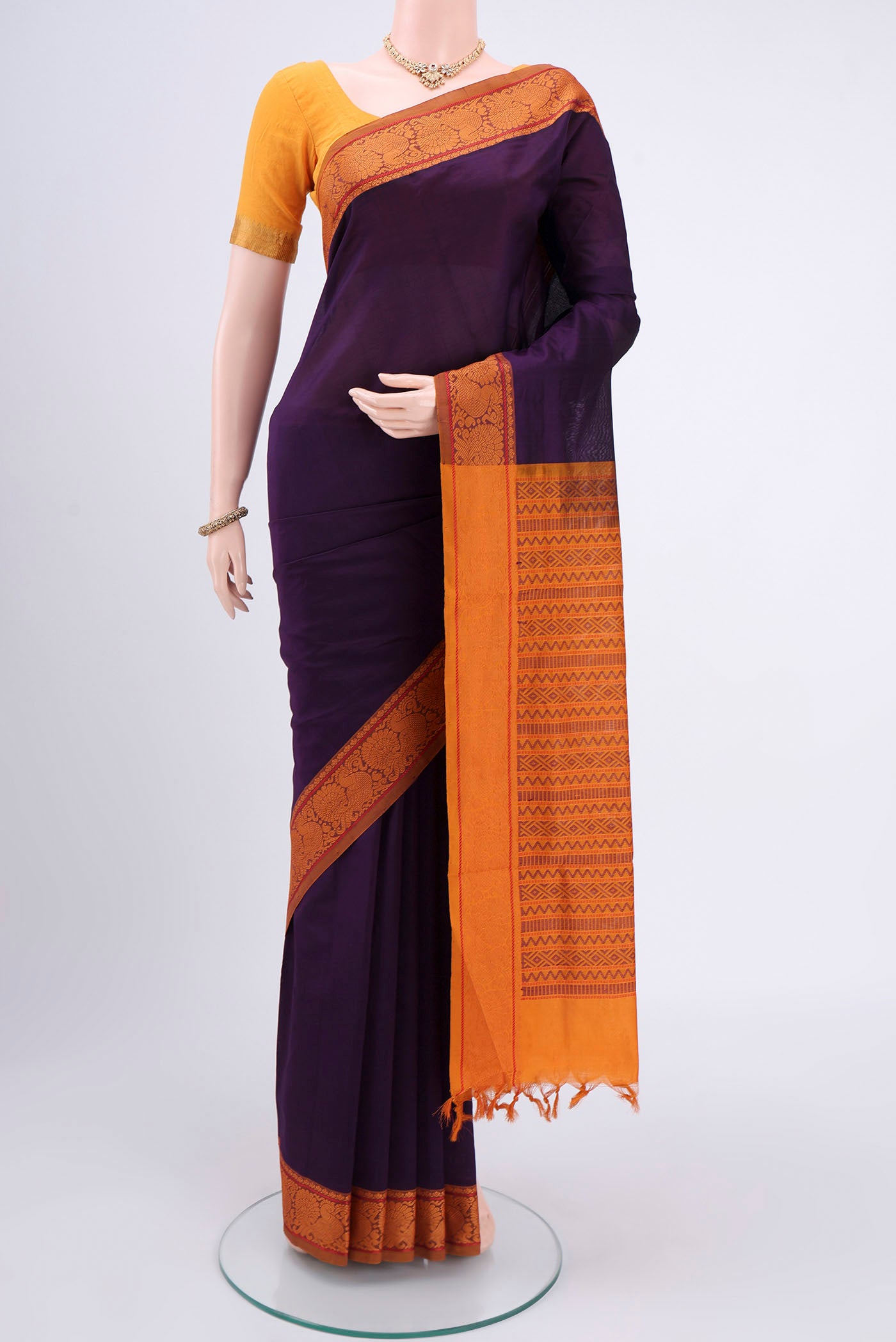 Burgundy Blended Poly Cotton Saree with Plain Body and Thread Border.  displayed on a mannequin