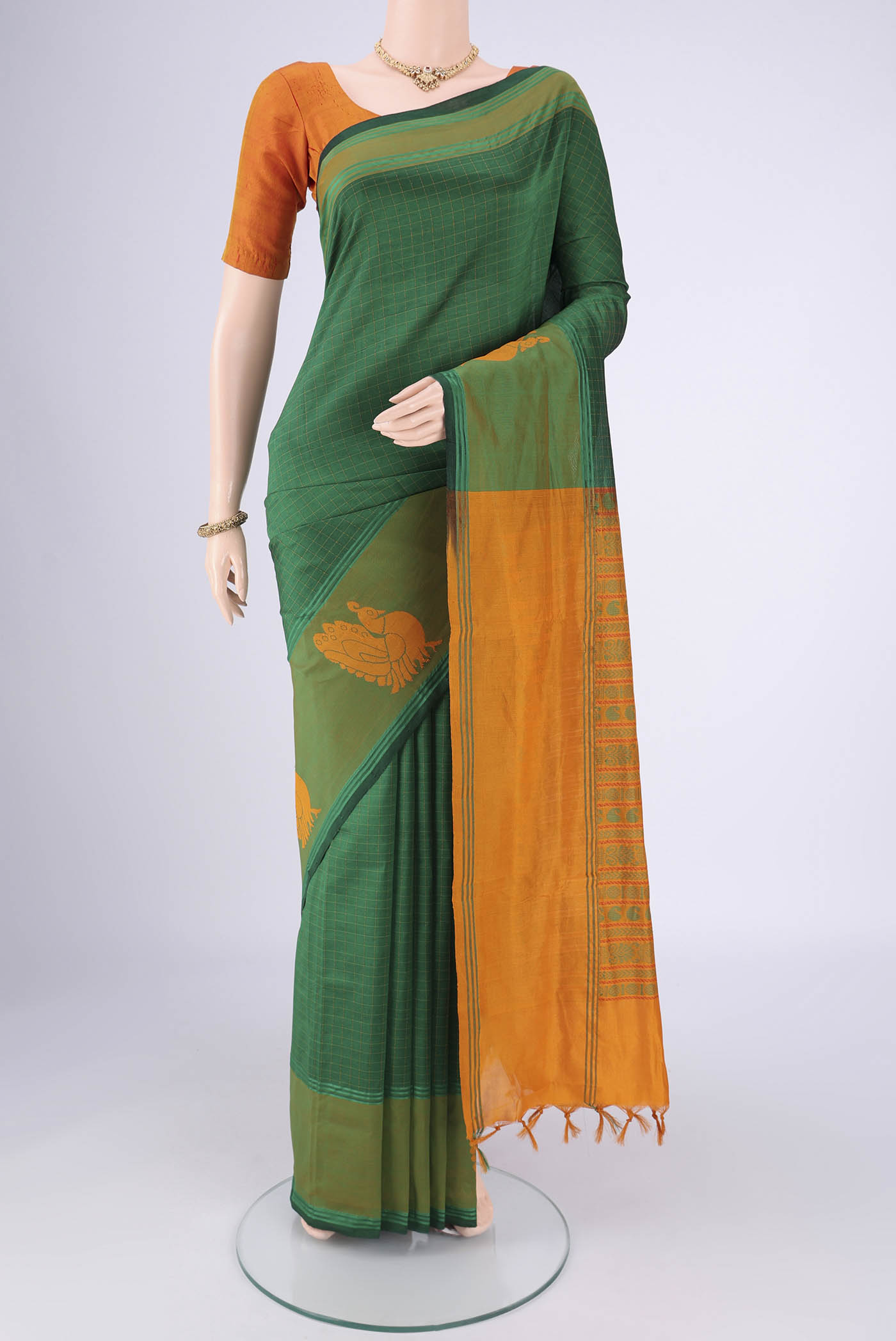 Bottle Green Blended Poly Cotton Saree with Checked design on the body and Thread Border.  displayed on a mannequin