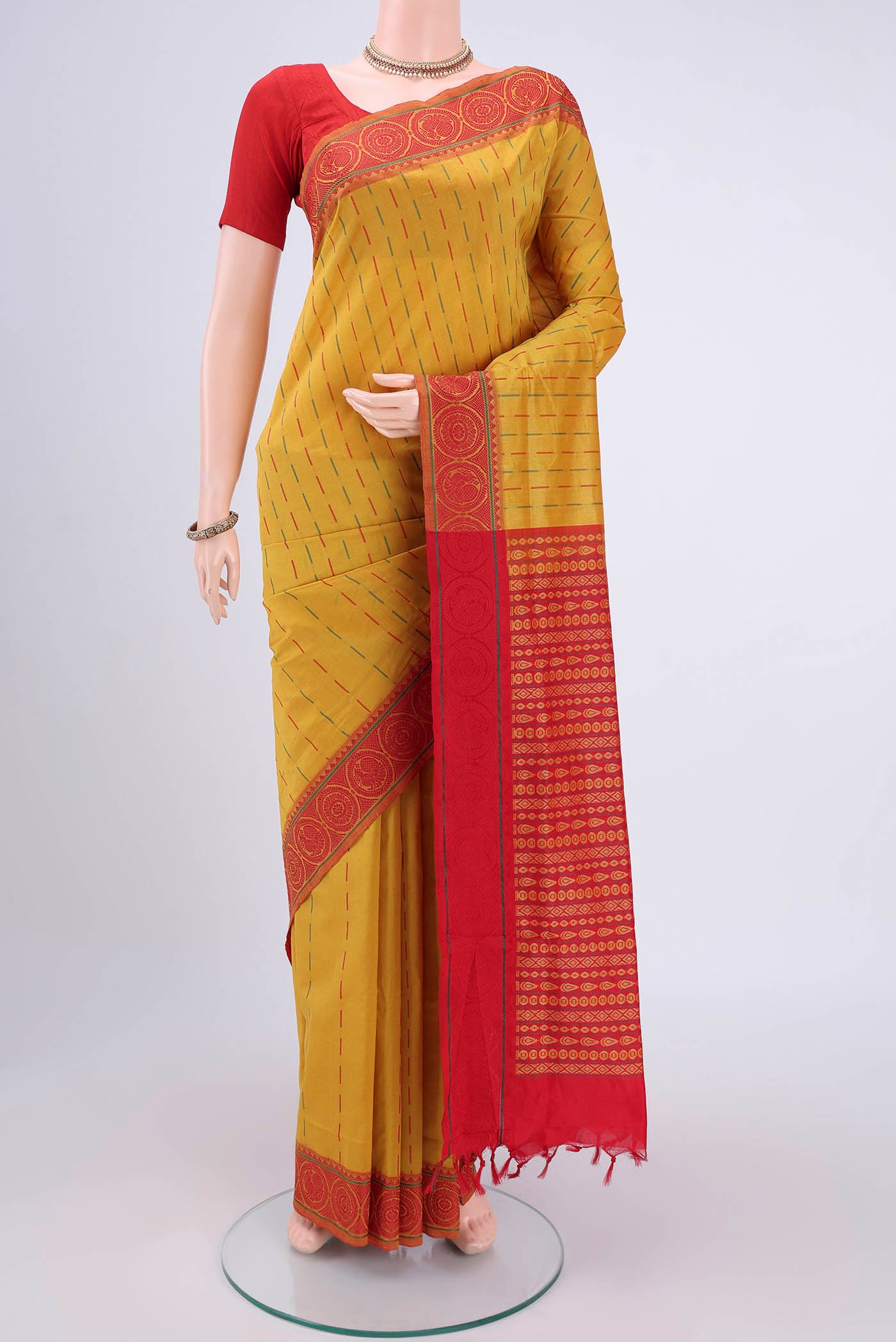Mustard Blended Poly Cotton Saree with Thread Butta on the body and Thread Border.  displayed on a mannequin