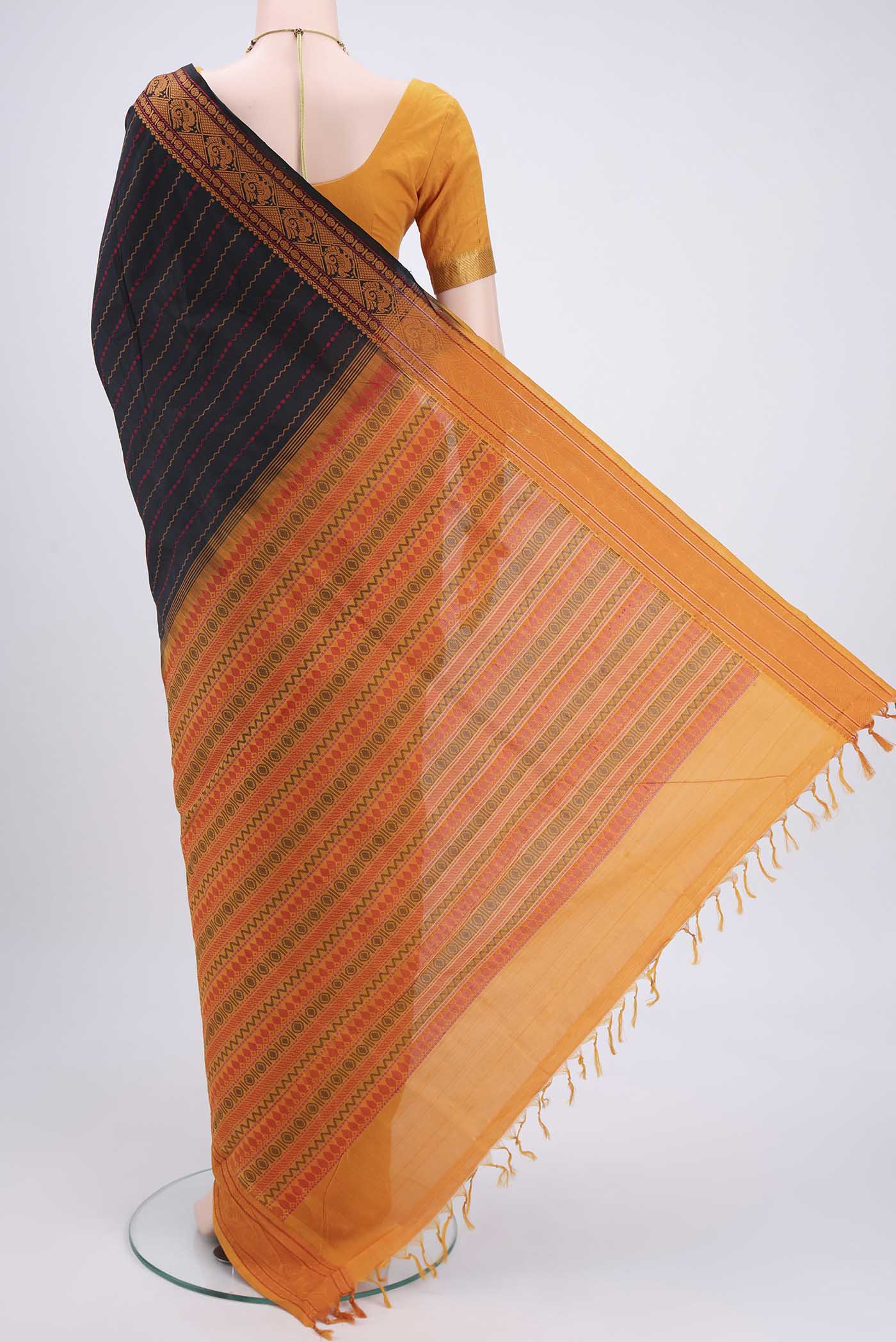 Flat view of Black Blended Poly Cotton Saree with Stripes on the body and Thread Border. 