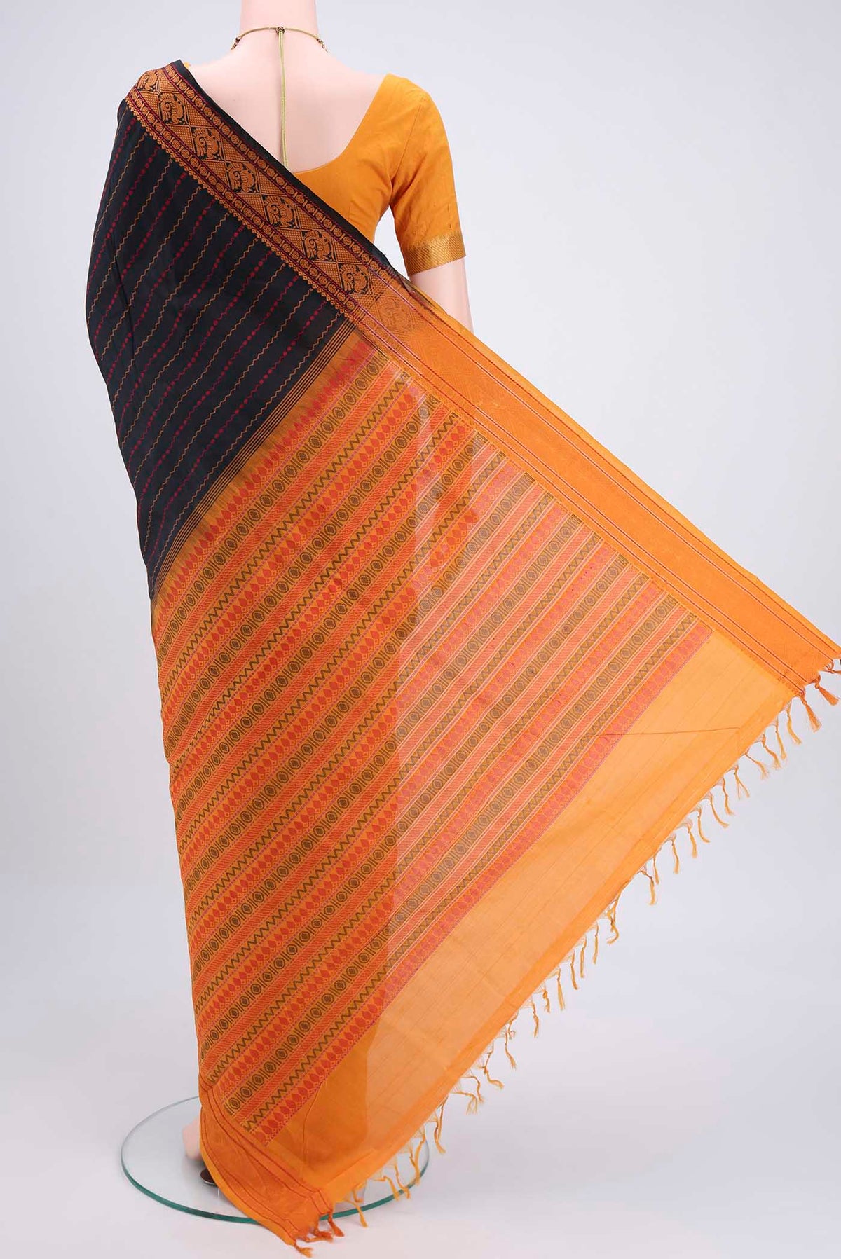 Flat view of Black Blended Poly Cotton Saree with Stripes on the body and Thread Border. 