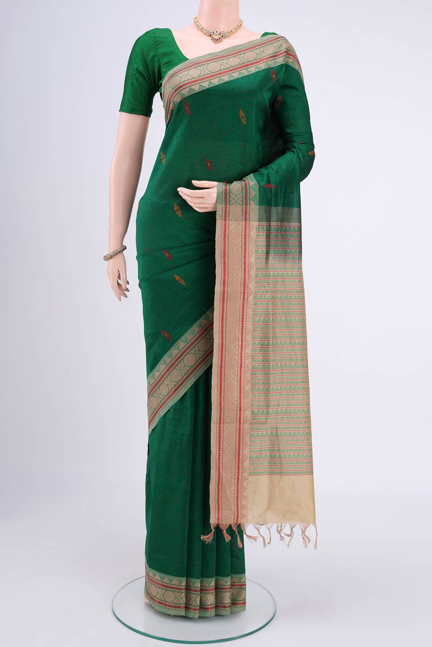 Bottle Green Blended Poly Cotton Saree with Thread Butta on the body and Thread Border.  displayed on a mannequin