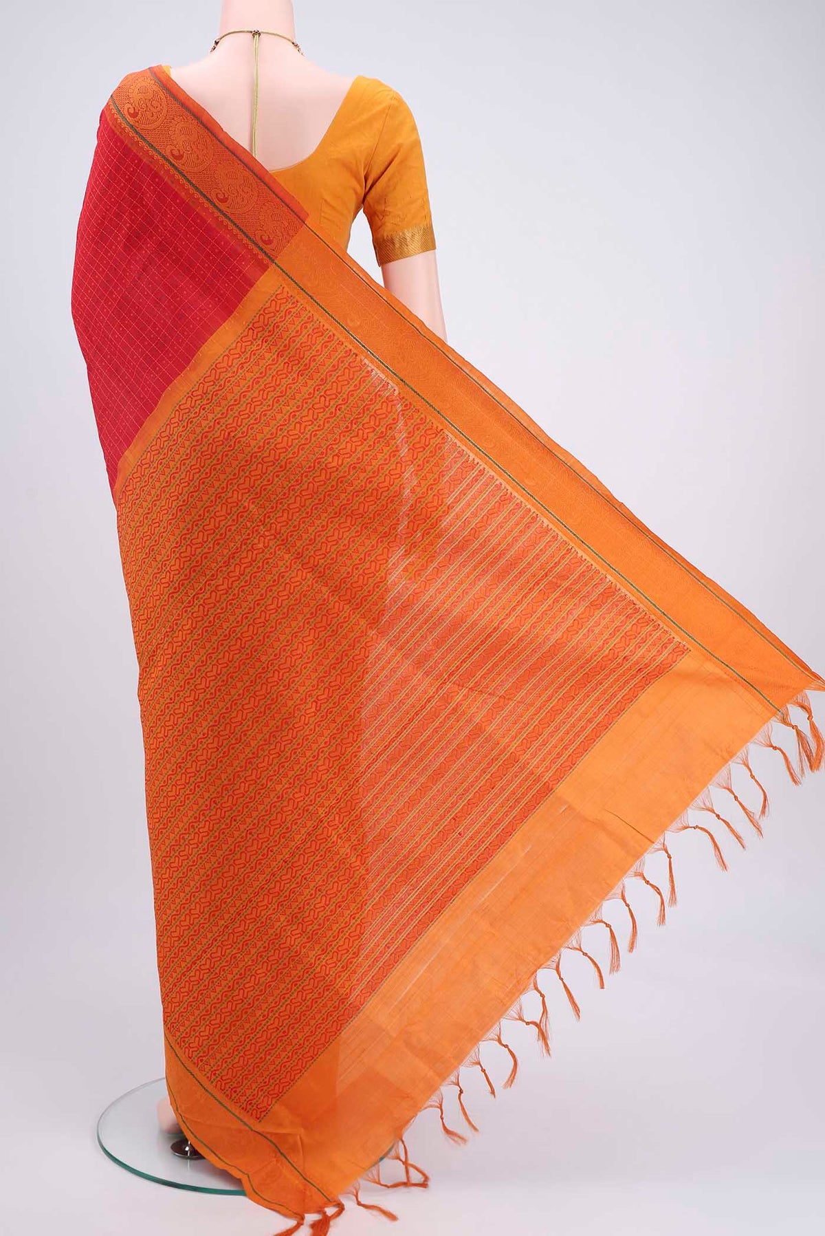 Flat view of Red Blended Poly Cotton Saree with Checked design on the body and Thread Border. 