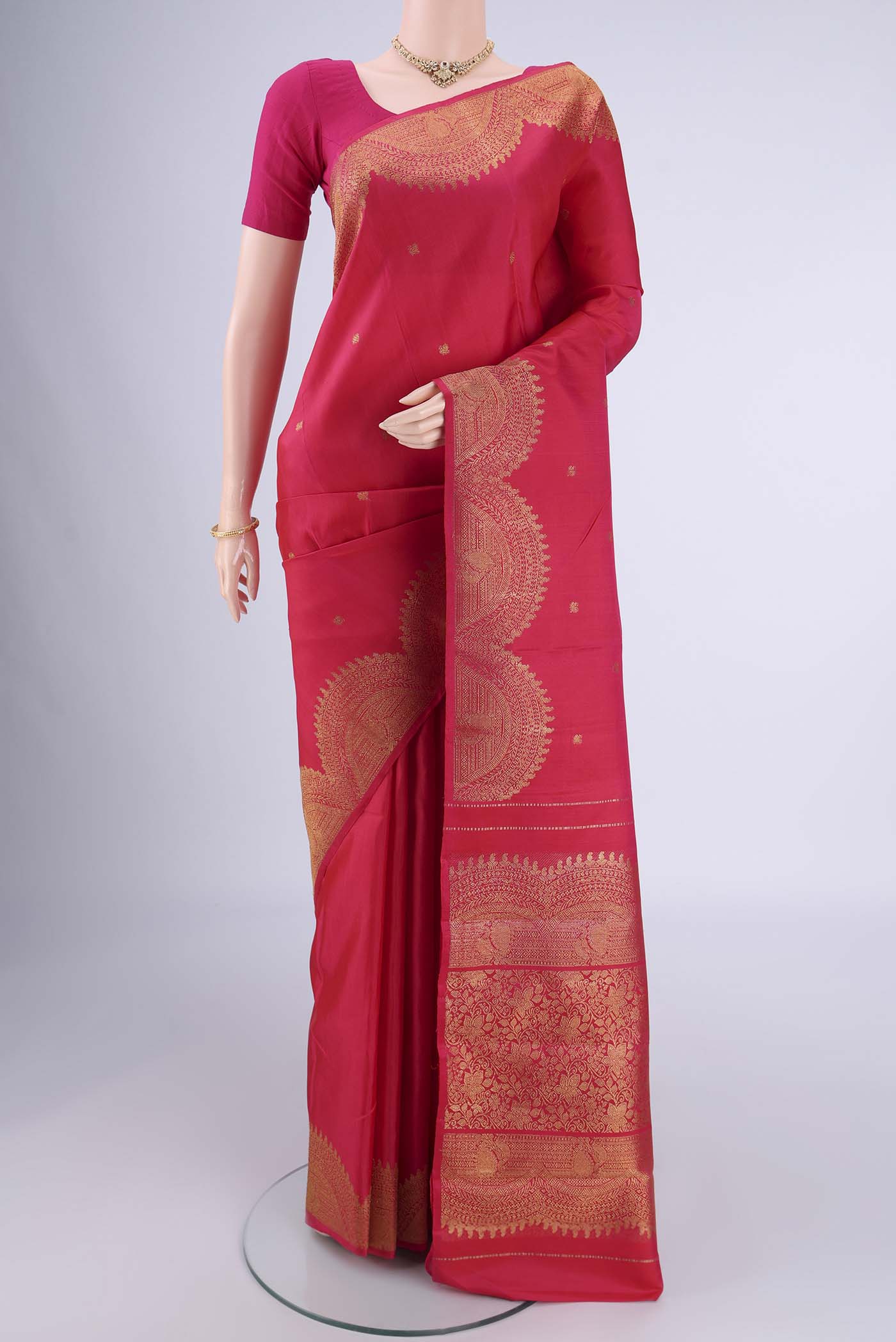 Pure Silk Pure Zari Pink Kanchipuram Saree with Zari Butta on the body and Fancy Border.  displayed on a mannequin