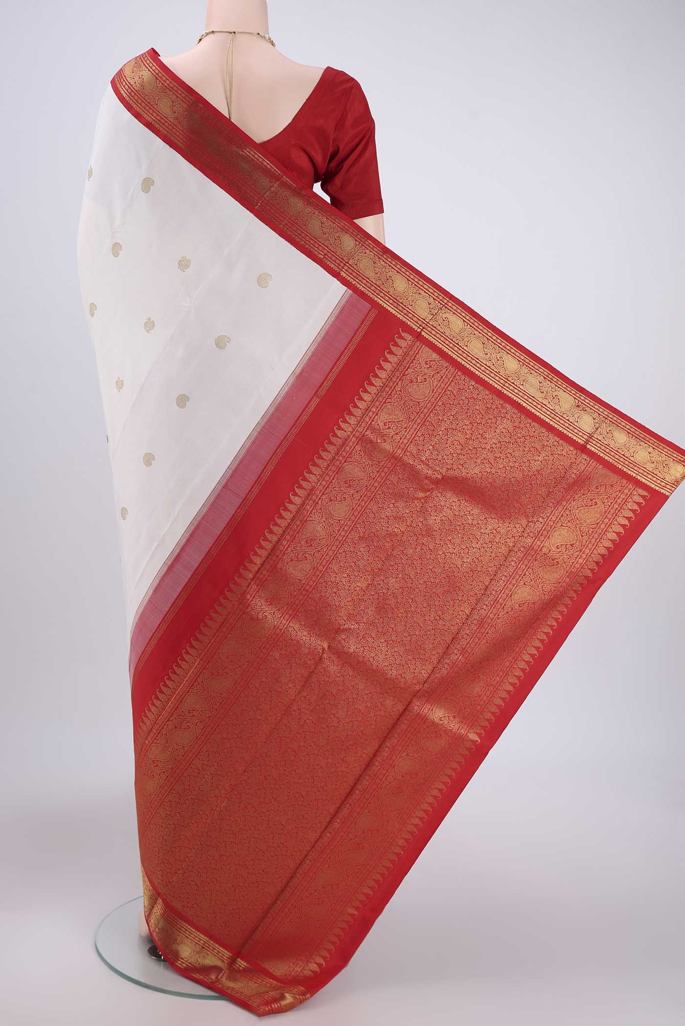 Flat view of White Kanjivaram Saree with Zari Butta on the body and Zari Border. 