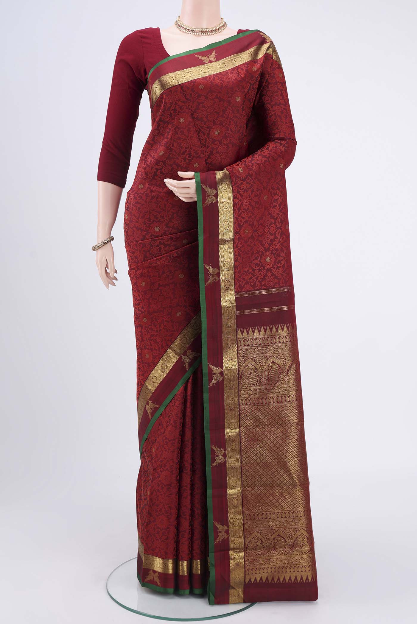 Maroon Kanchipuram Silk Saree with Jacquard With Zari Butta on the body and Zari Border.  displayed on a mannequin