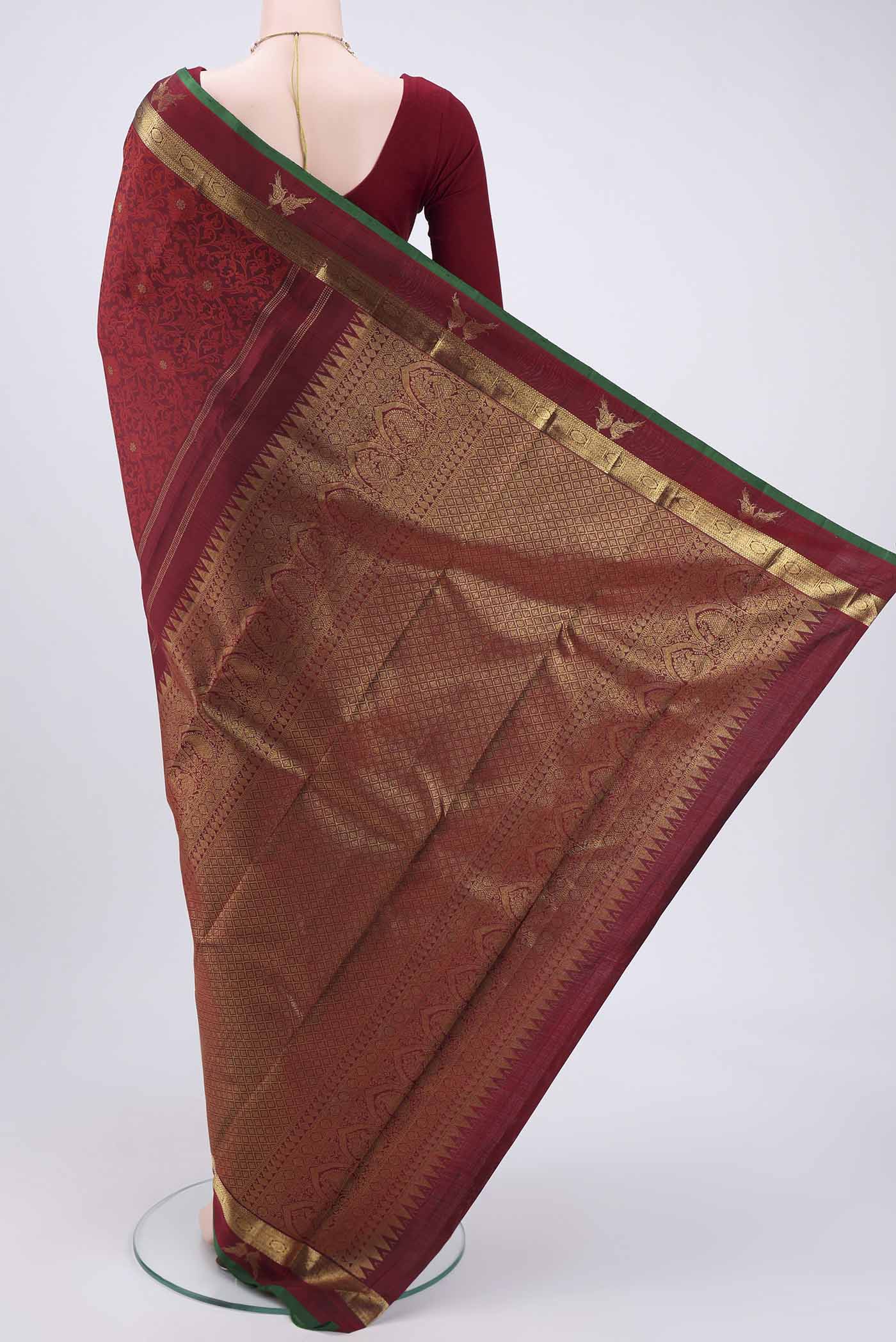 Flat view of Maroon Kanchipuram Silk Saree with Jacquard With Zari Butta on the body and Zari Border. 
