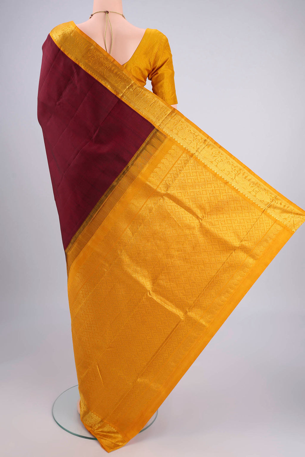Flat view of Maroon Kanjivaram Silk Saree with Plain Body and Zari Border. 