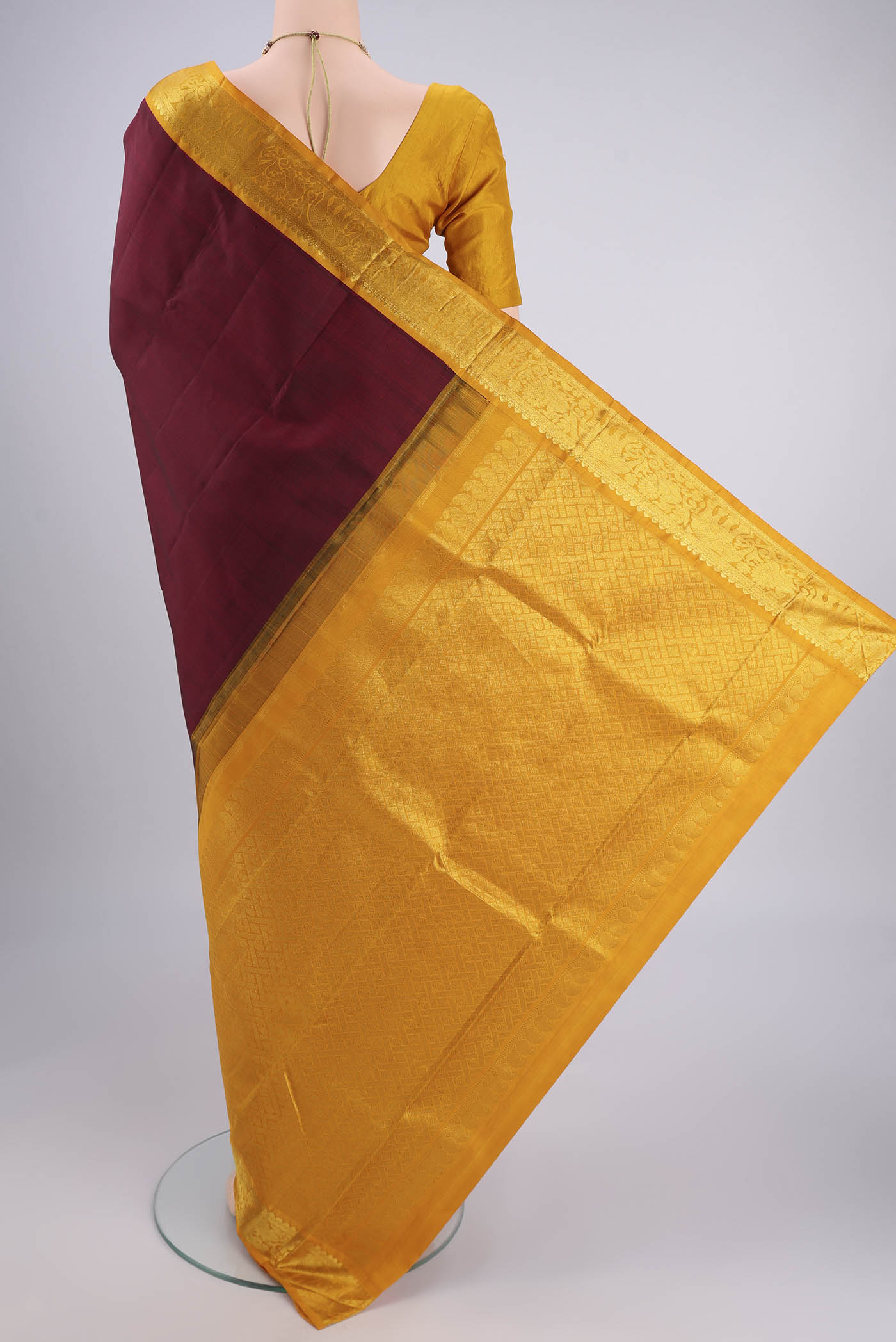 Flat view of Maroon Kanjivaram Silk Saree with Plain Body and Zari Border. 