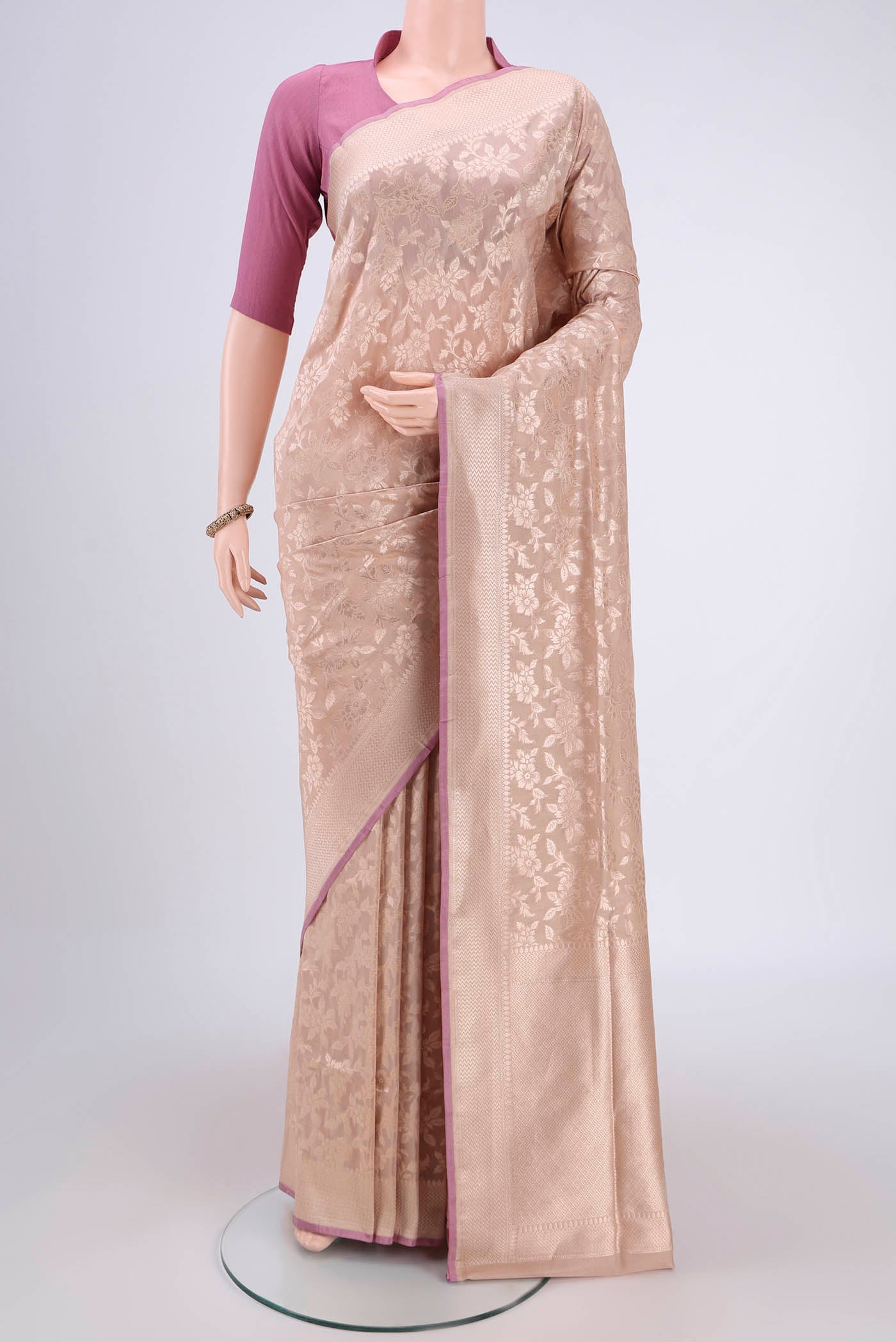 Beige Banarasi Silk Saree with Zari Butta on the body and Zari Border.  displayed on a mannequin