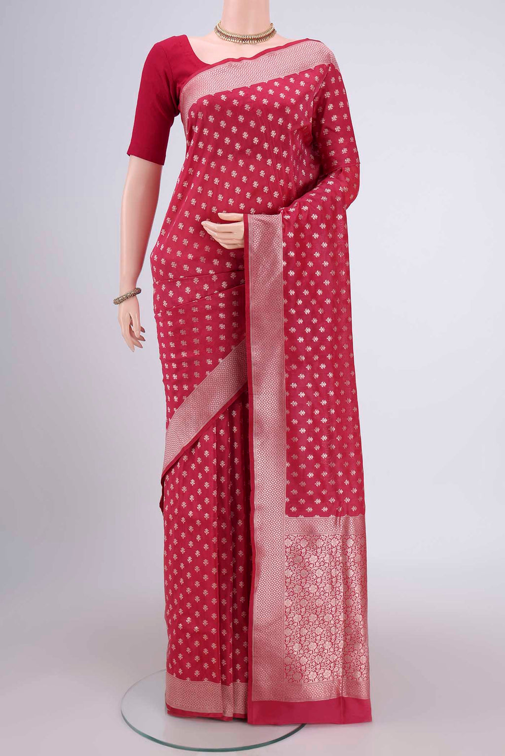Rose pink Banarasi Silk Saree with Zari Butta on the body and Zari Border.  displayed on a mannequin