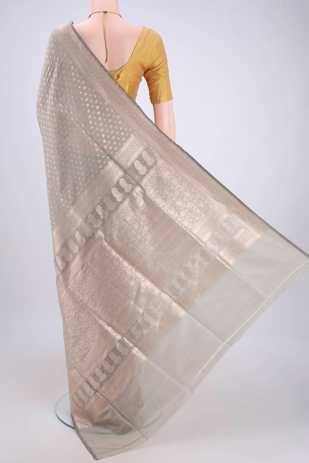 Flat view of Grey Banarasi Silk Saree with Zari Butta on the body and Zari Border. 