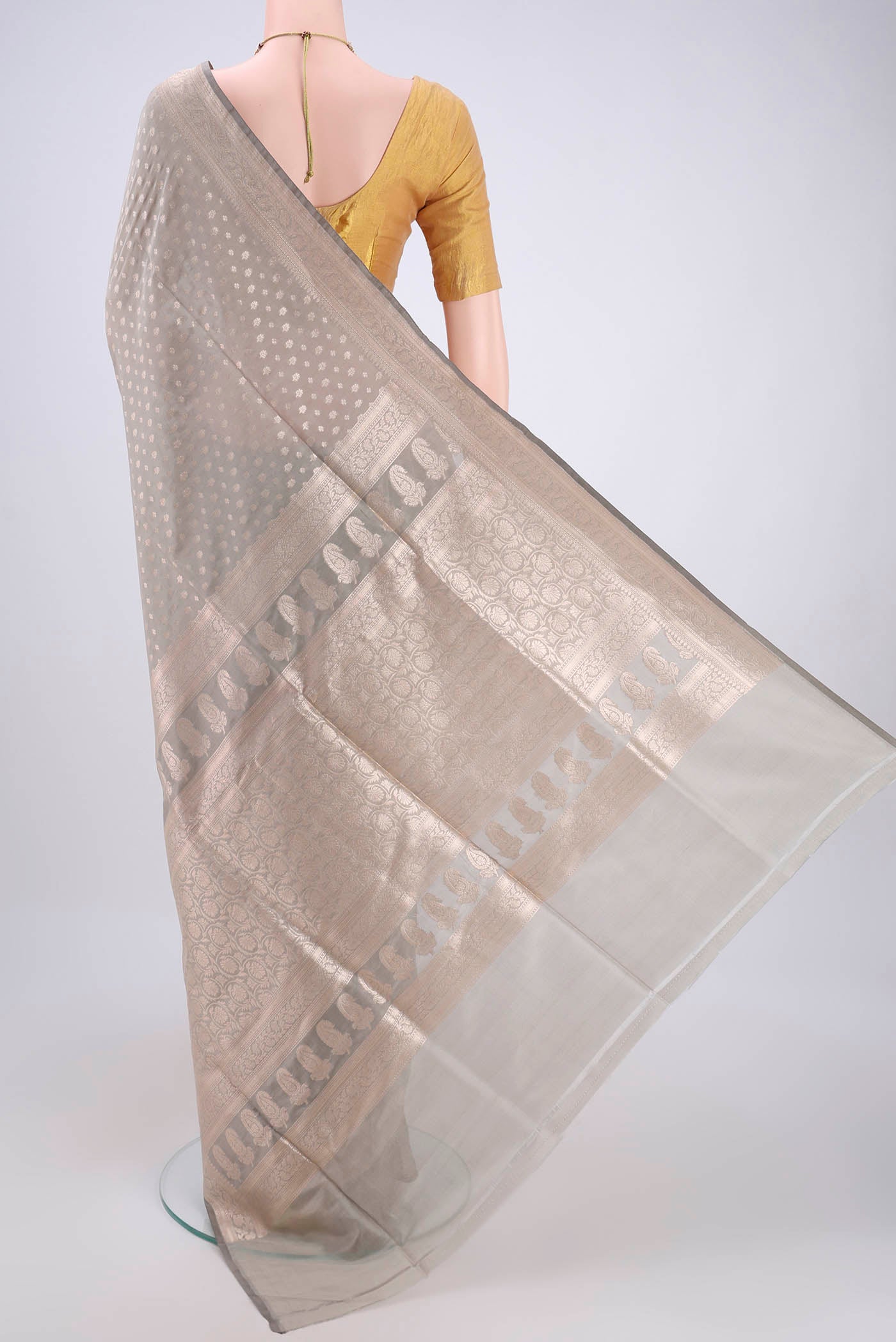 Flat view of Grey Banarasi Silk Saree with Zari Butta on the body and Zari Border. 