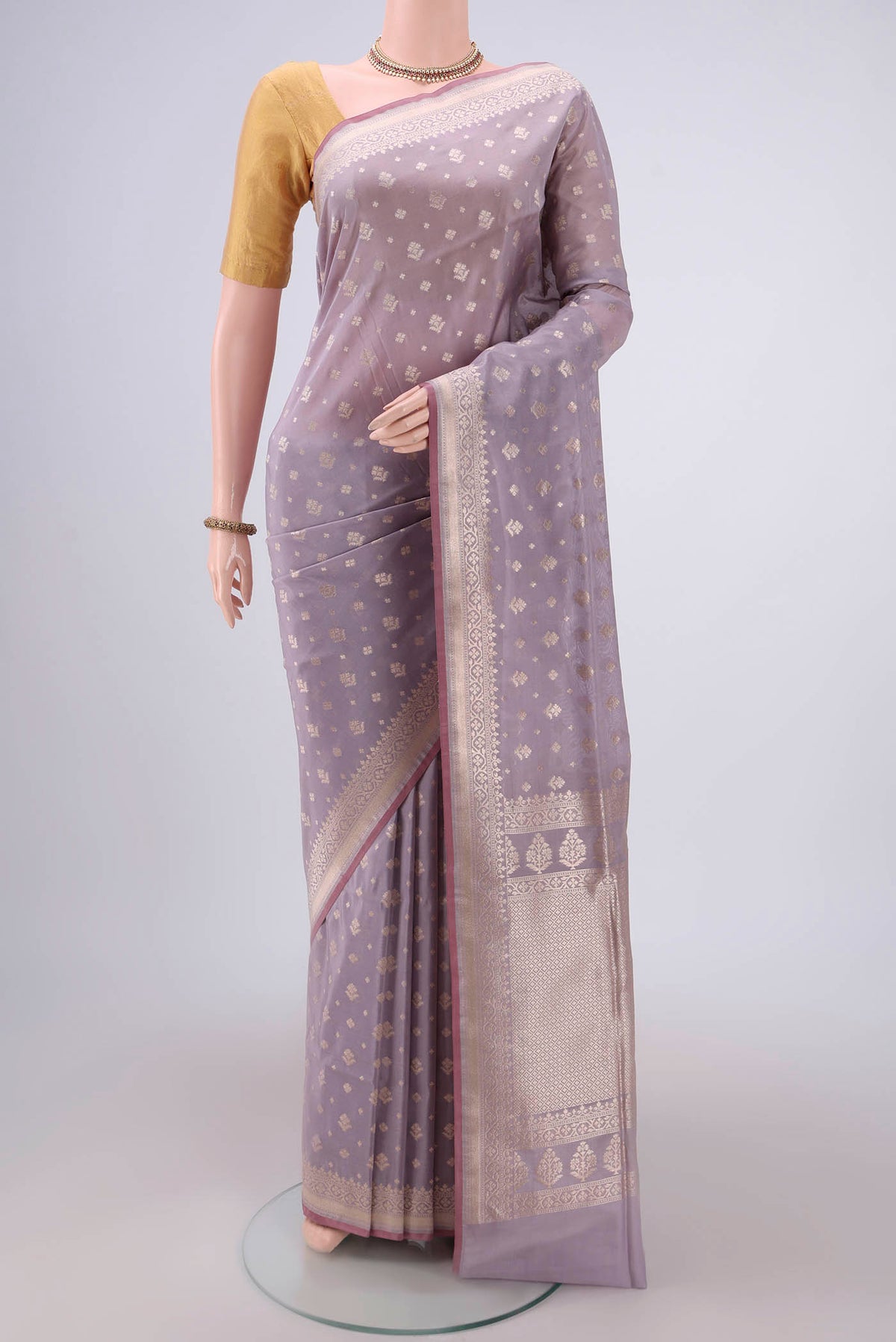 Lavender Dual Tone Banarasi Silk Saree with Zari Butta on the body and Zari Border.  displayed on a mannequin