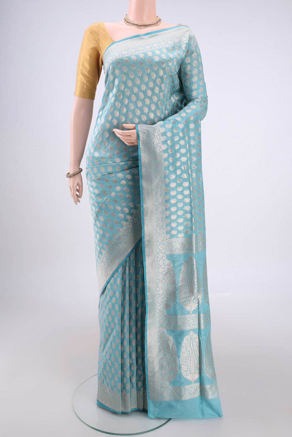 Sky Blue Banarasi Silk Saree with Zari Butta on the body and Zari Border.  displayed on a mannequin