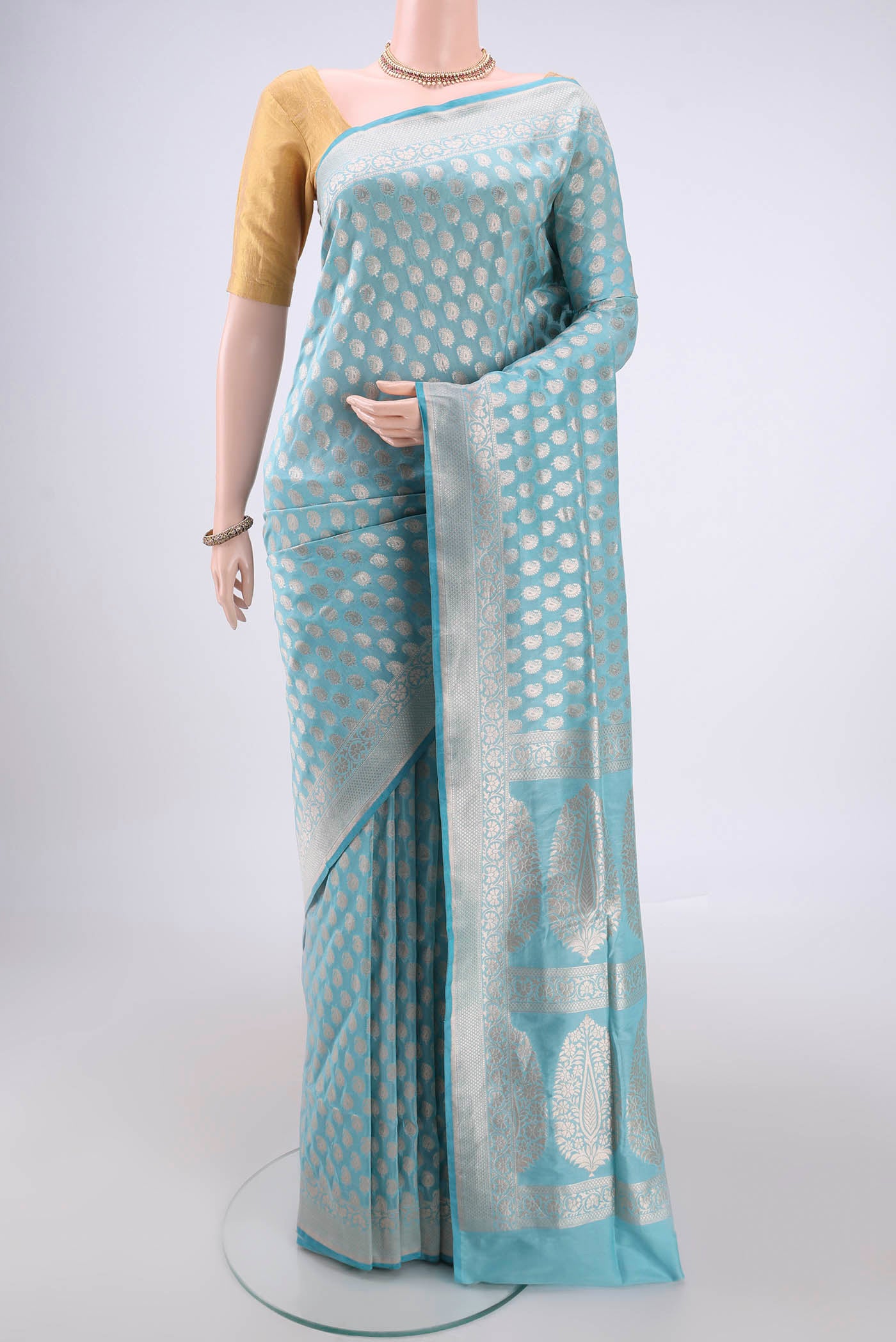 Sky Blue Banarasi Silk Saree with Zari Butta on the body and Zari Border.  displayed on a mannequin