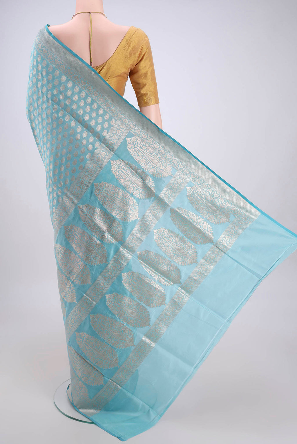 Flat view of Sky Blue Banarasi Silk Saree with Zari Butta on the body and Zari Border. 
