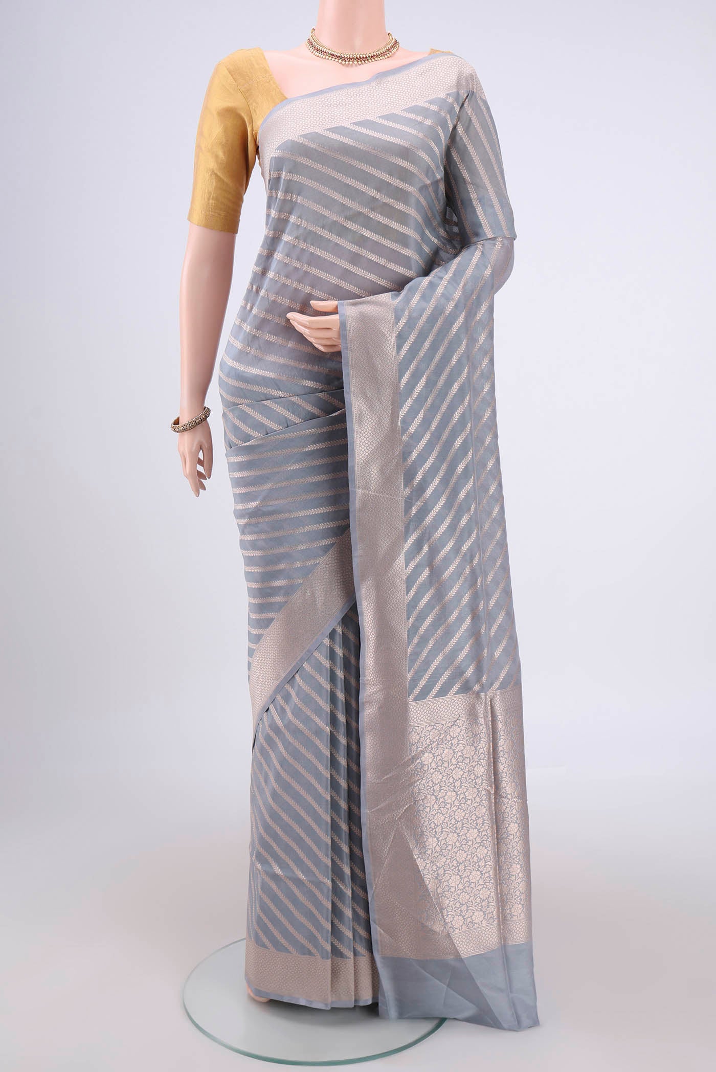 Blue Grey Banarasi Silk Saree with Stripes on the body and Zari Border.  displayed on a mannequin