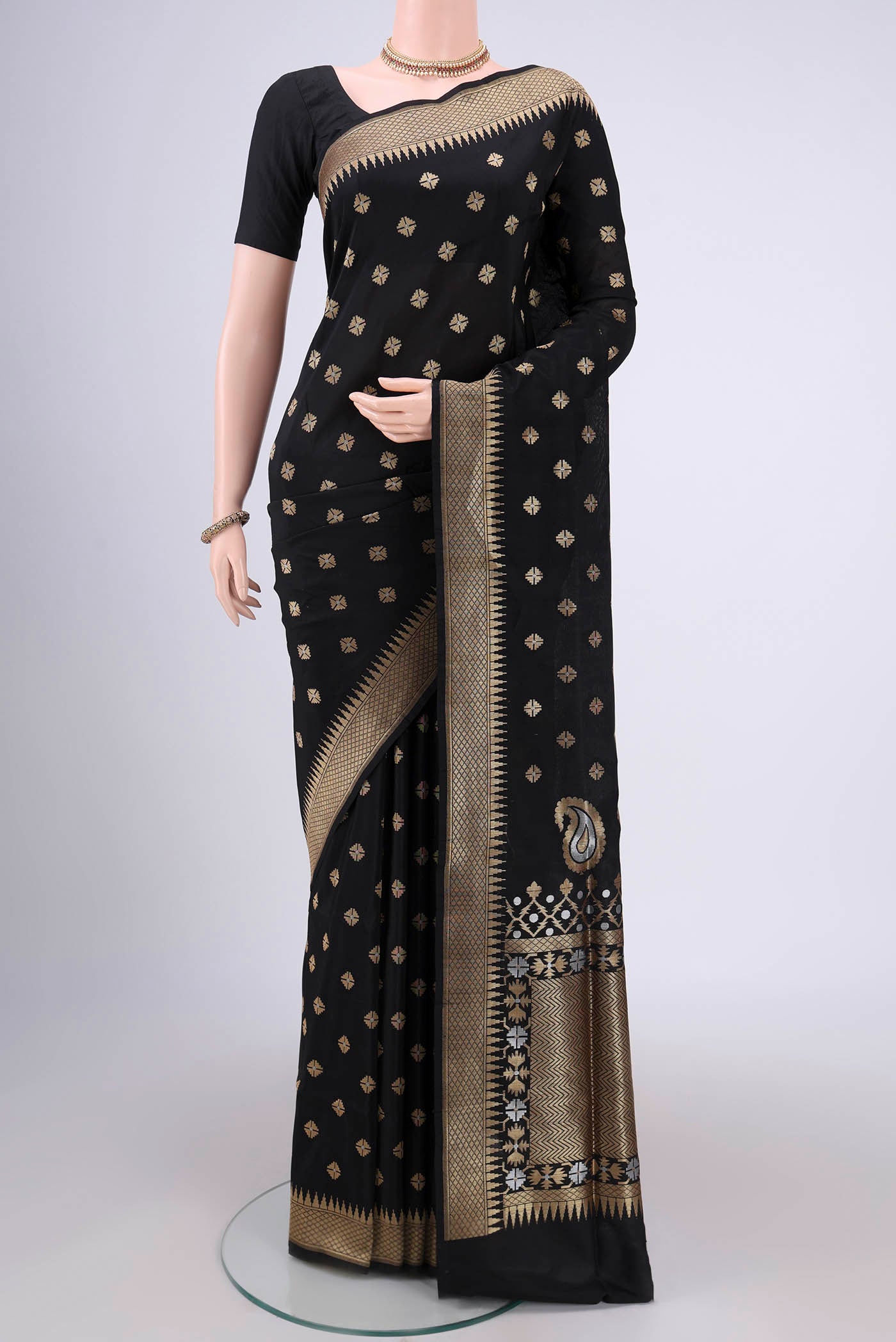 Black Banarasi Silk Saree with Zari Butta on the body and Temple Border.  displayed on a mannequin