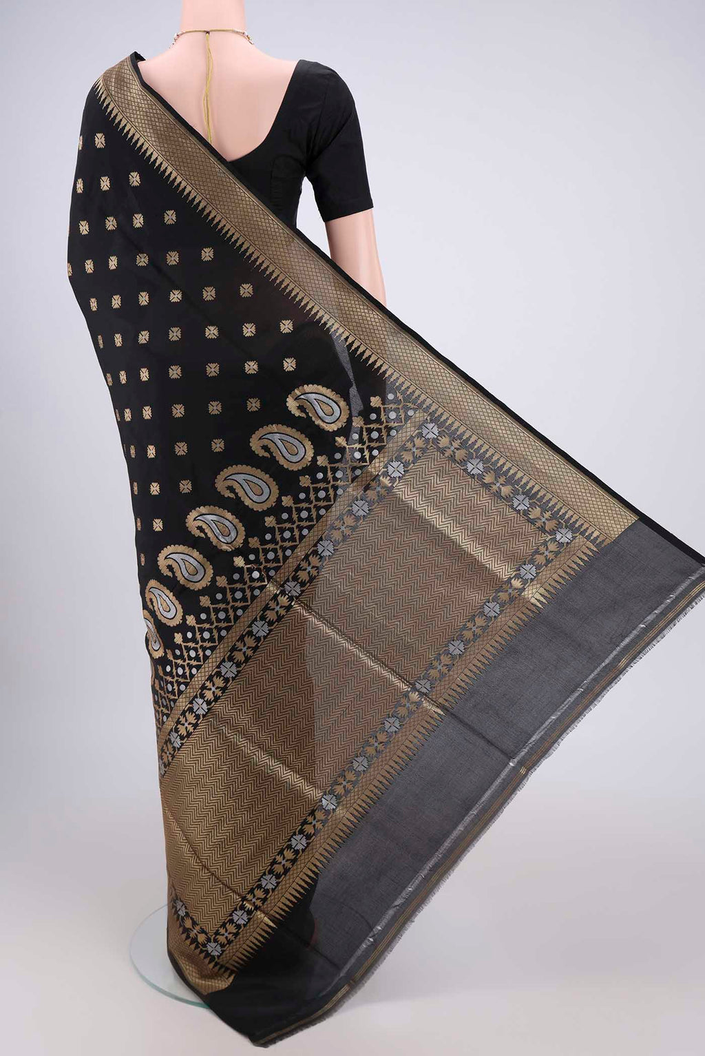 Flat view of Black Banarasi Silk Saree with Zari Butta on the body and Temple Border. 