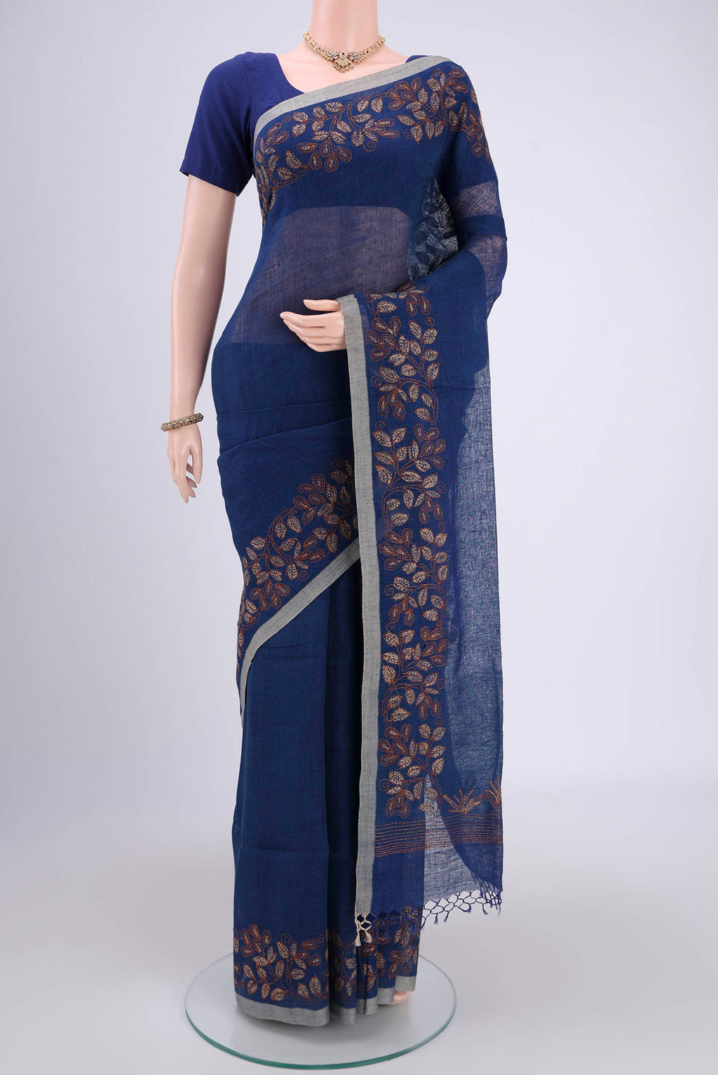 Blue Linen Saree with Kantha Work on the body and Plain Border.  displayed on a mannequin