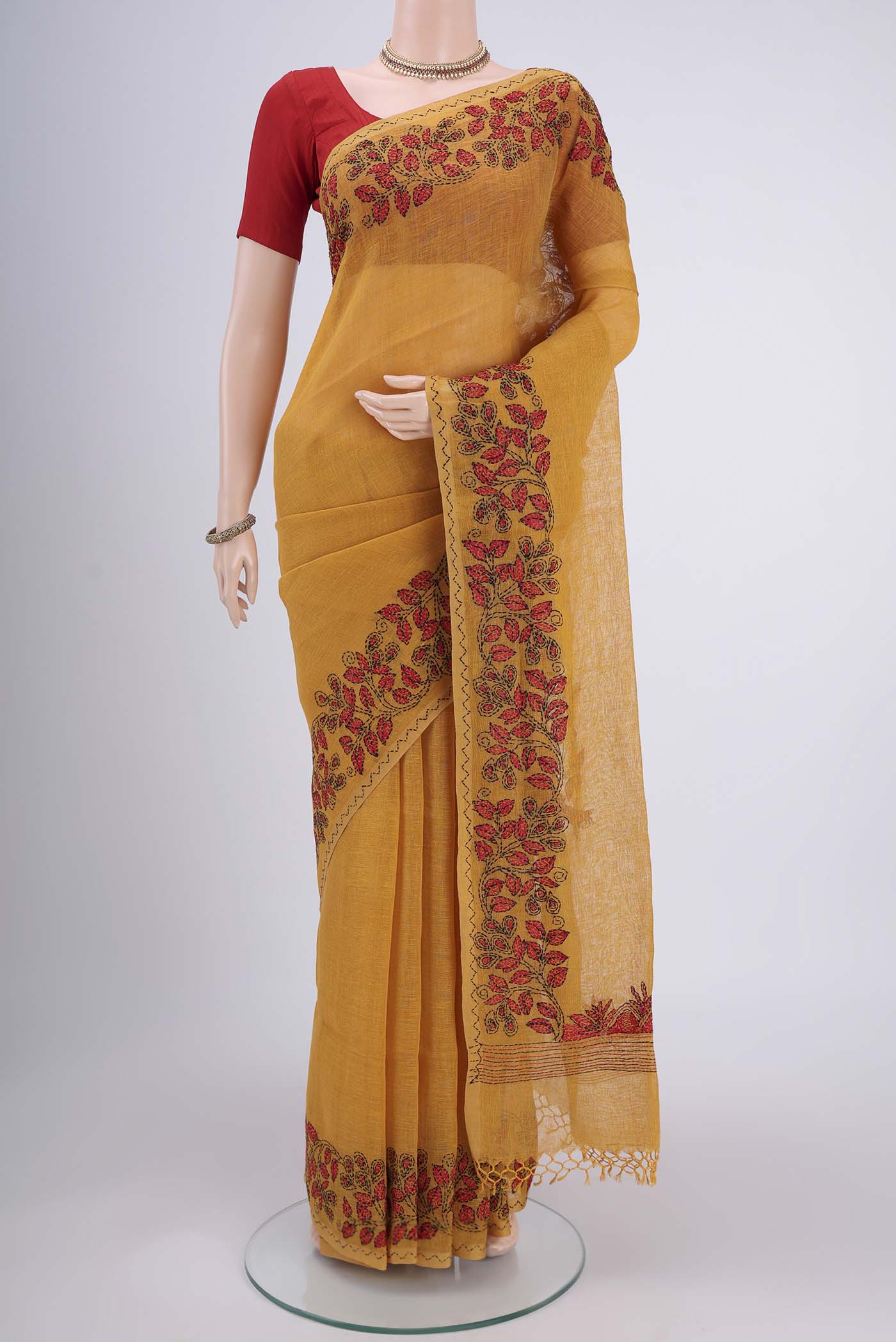 Mustard Linen Saree with Plain Body and Thread Border.  displayed on a mannequin