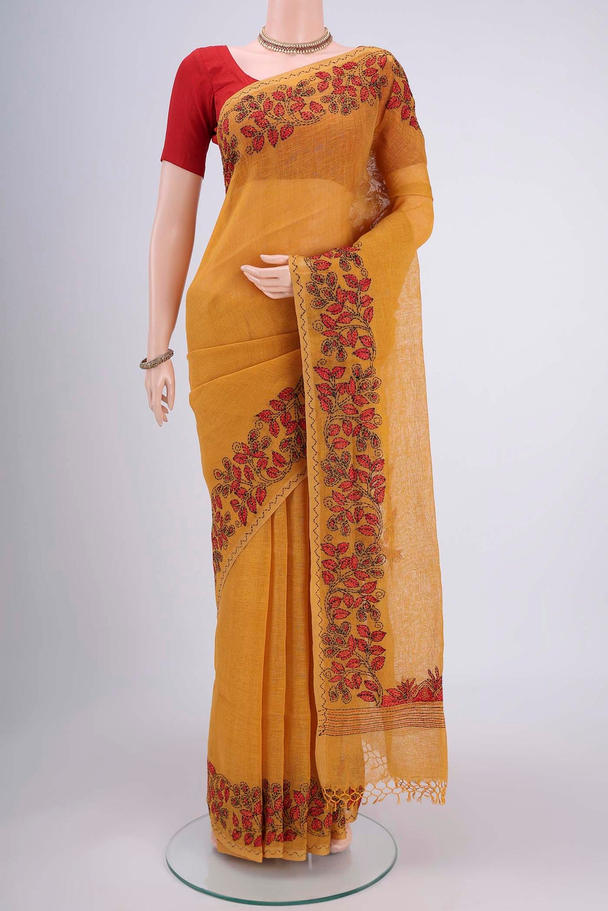 Mustard Linen Saree with Plain Body and Thread Border.  displayed on a mannequin